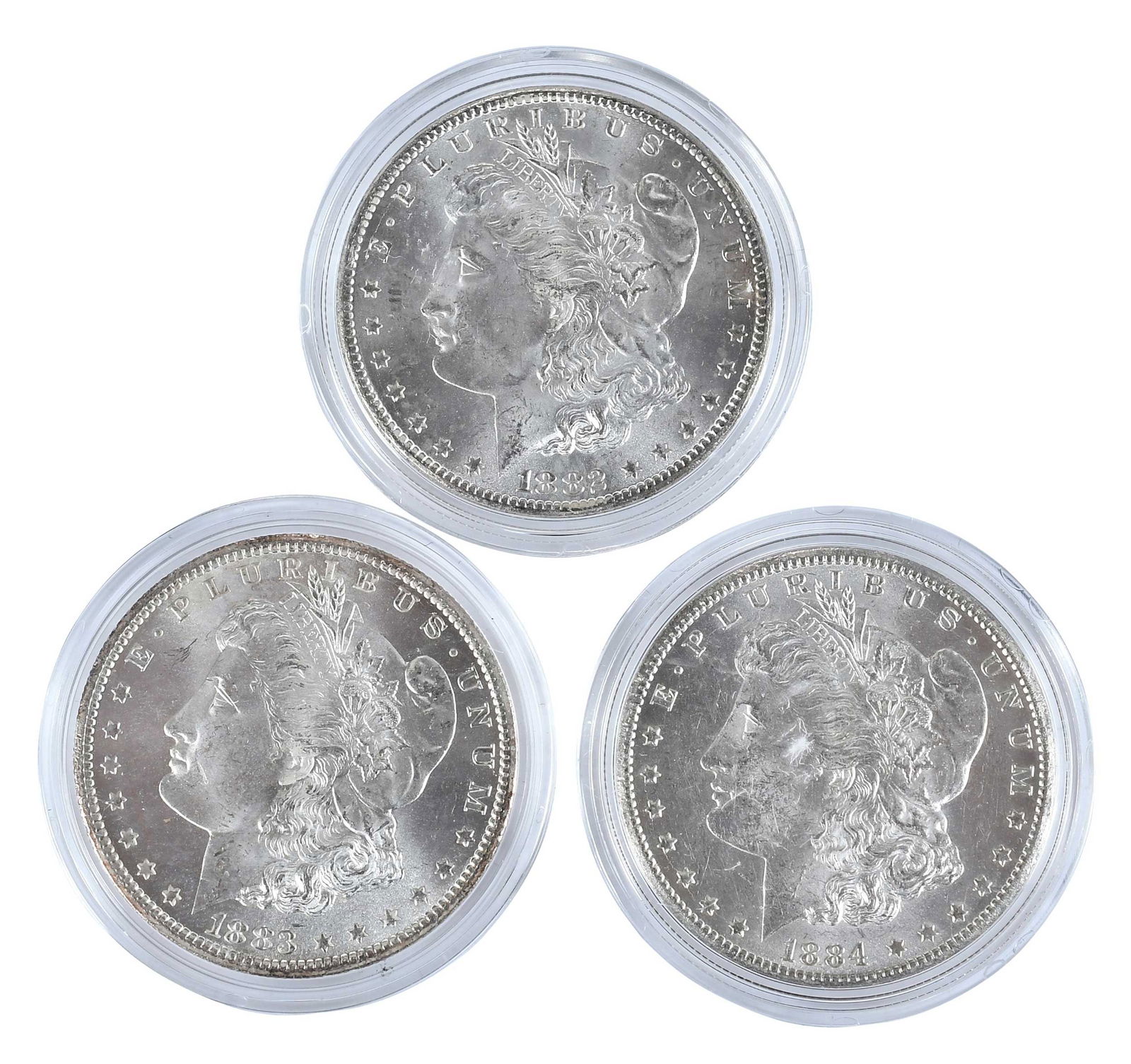 Three Carson City Morgan Dollars: 1882, 1883, 1884 in Capsules: Carson City dollars Provenance: Private Collection