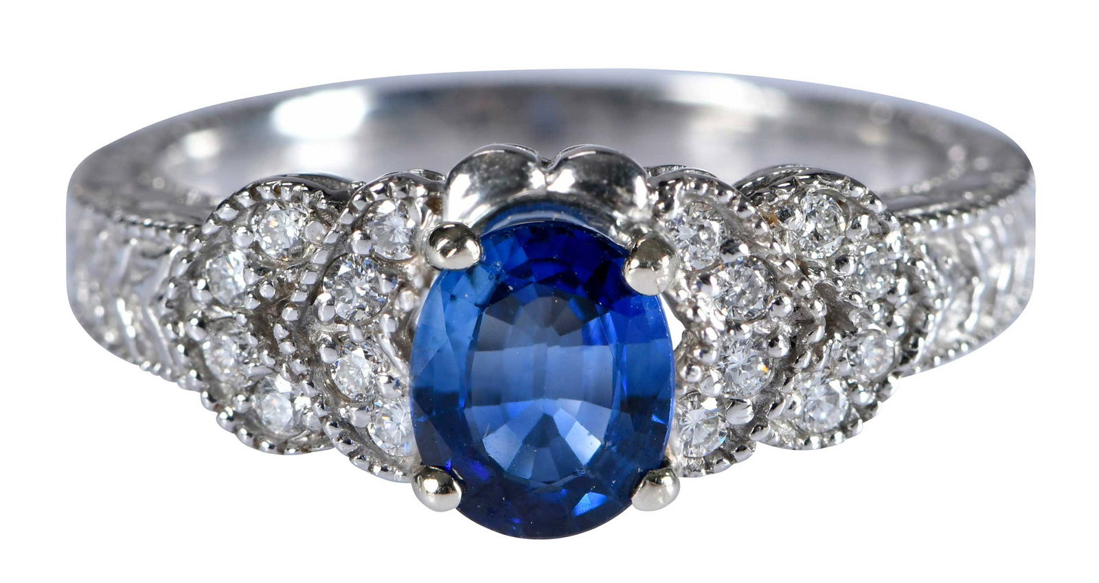 14kt. Vintage Style Blue Sapphire and Diamond Filigree and Milgrain Ring: oval modified mixed cut blue sapphire, approx. 0.75ct., 16 round full cut diamonds, marked "14K", white gold, 6-1/2 ring sz., 4.7 g Provenance: Estate of Linda Sargent Thompson, Historic Sesame Lodge,