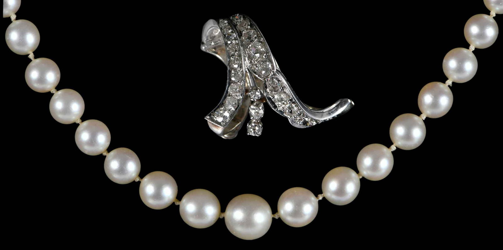 Vintage Platinum Pearl Strand with Diamond Clasp and Diamond Enhancer: single strand, graduating in size, 9.5mm - 7.0mm, 22 old European and rose cut diamonds, approx. 0.70ctw., tests platinum, 22 in. length; 23 old European cut diamonds, approx. 0.50ctw., tests