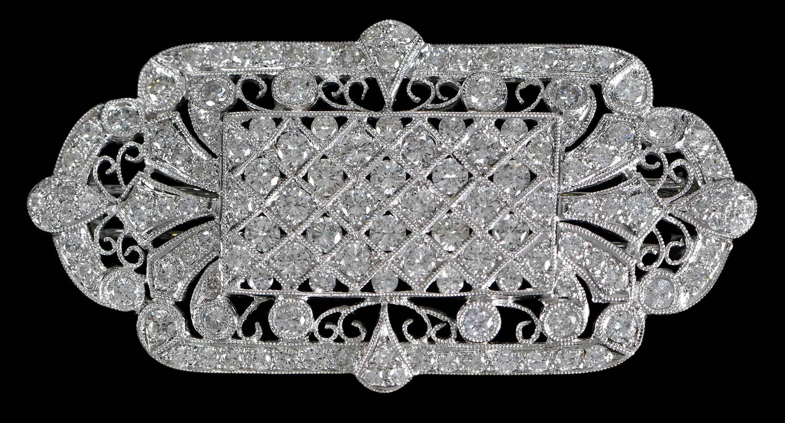 18kt. Vintage Diamond Art Deco Open Work Fur Brooch: center pattern has 38 round full cut diamonds, approx. 1.50ctw., pierced areas with milgraining, embellished with round full cut diamonds, marked "750", white gold, 2-1/8 in. length, 1-1/8 in. width,