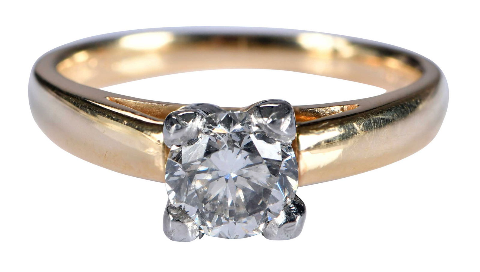 18kt. and Platinum Classic Solitaire Diamond Ring: round brilliant cut diamond, approx. 1.00ct., SI, H-I, platinum four prong mounting, marked "IGI 7687570, PLAT, 18kt.", yellow gold shank, 7 ring sz., 6.2 g Provenance: Estate of Linda Sargent Thompso