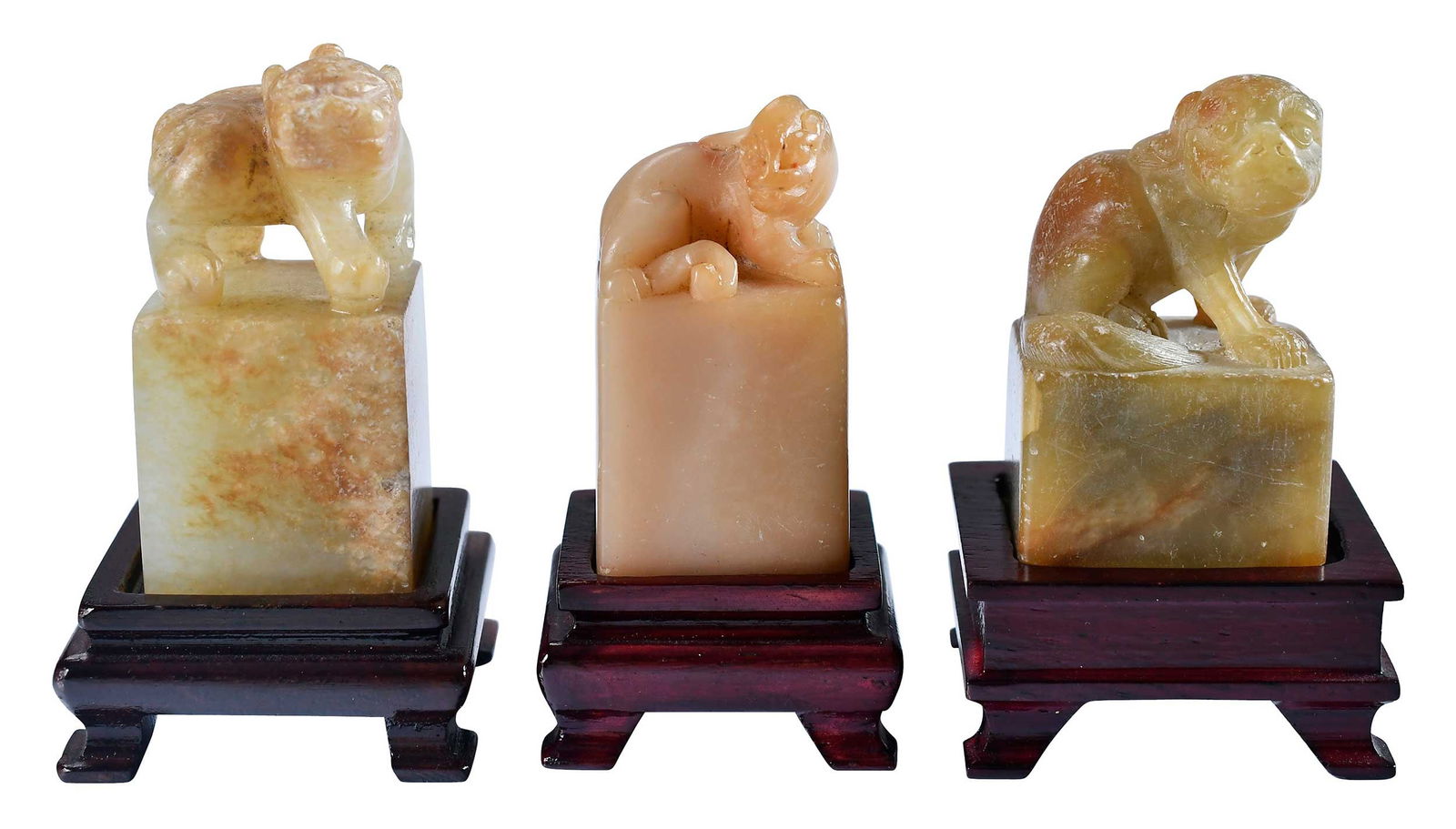 Three Chinese Carved Hardstone Seals with Stands: each of square form with fu lion or chilong finial, each with conforming wood stand, largest 2-1/2 x 1-1/2 x 1-1/2 in. with standProvenance: The Lifetime Collection of Ronald Elliott Hasbrouck