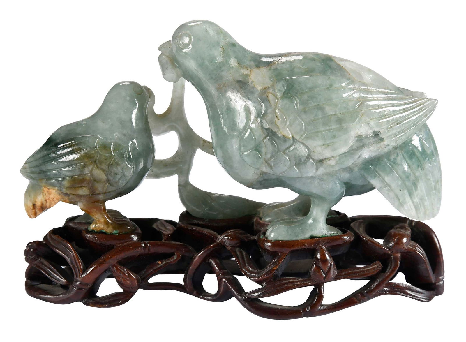 Carved Jade Quail Grouping: depicting two quails holding a plant sprig, mottled green jade with russet inclusions, on carved wood stand, 3-1/2 x 5-1/4 x 1-1/2 in.Note: This item tested as jadeite on the Presidium Gem Tester
