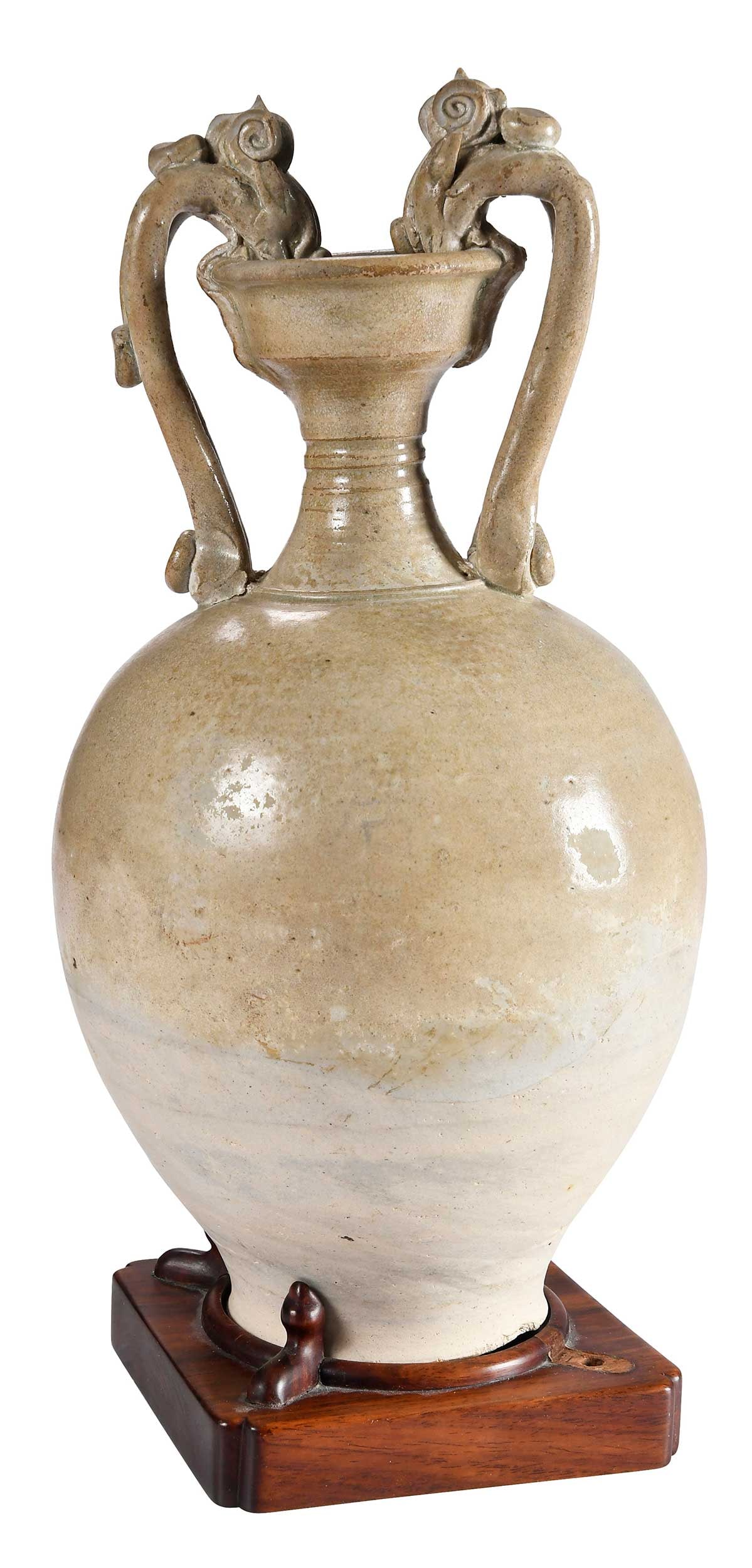 Chinese Straw-Glazed Stoneware Dragon Vase: possibly Tang dynasty, celadon glaze, dragon form handles, fitted on carved wood base, 14-5/8 x 7-1/4 x 7-1/4 in.Provenance: Collection of William W. Sauer, Virginia Beach, Virginia; sold to benefit