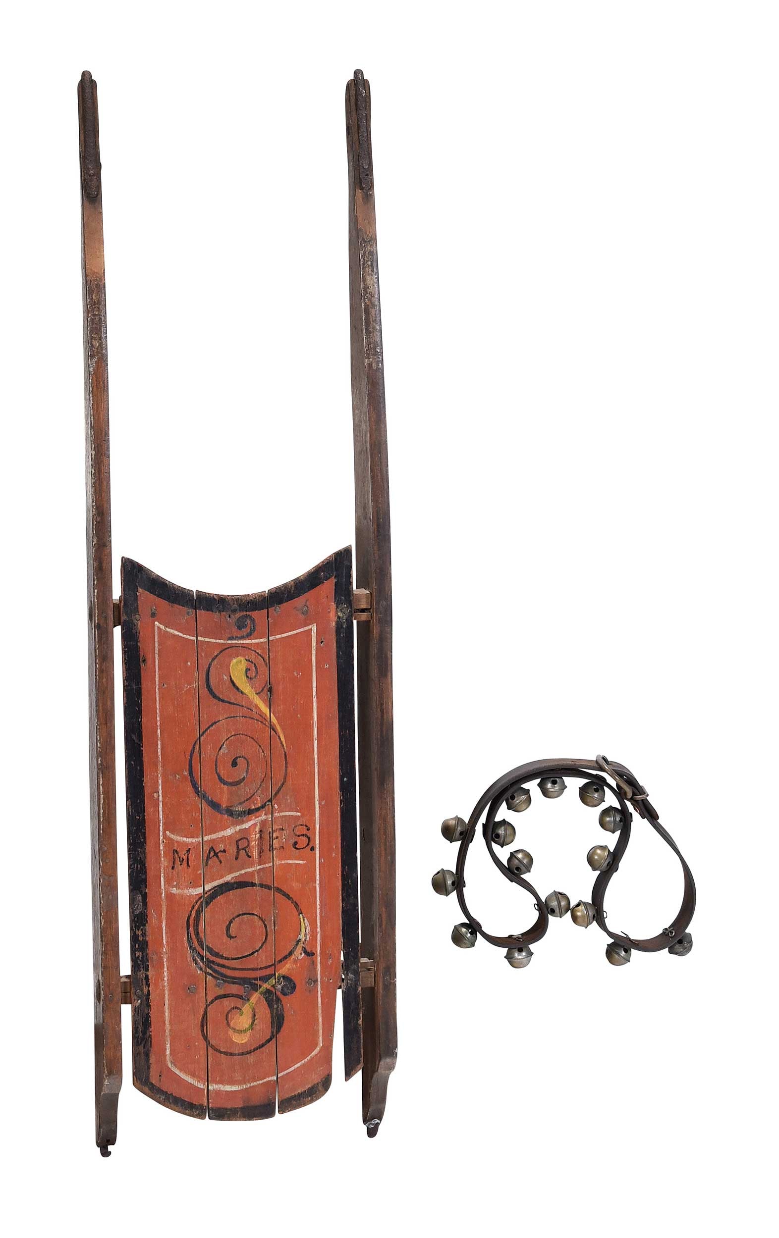American Red Painted and Carved Sleigh: 20th century, inscribed "MARIES" within scrolling decoration, 4 x 40-1/2 x 11-1/2 in.; together with strand of sleigh bellsProvenance: Private Collection, Georgetown, South Carolina