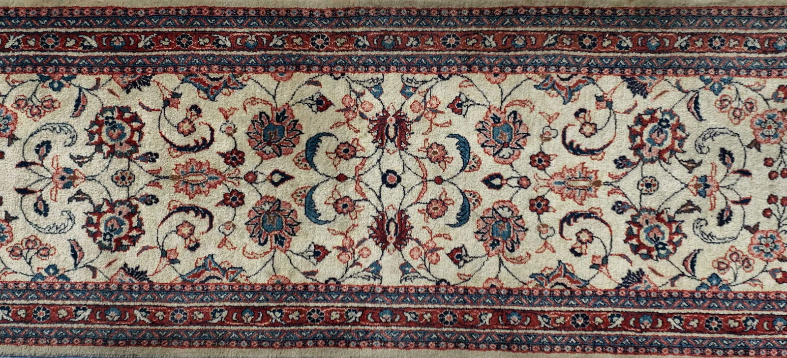 Persian Runner: 20th century, white field, red borders, floral leafy vines, 18 ft. x 2 ft. 8 in.Provenance: Private Collection, Raleigh, North Carolina