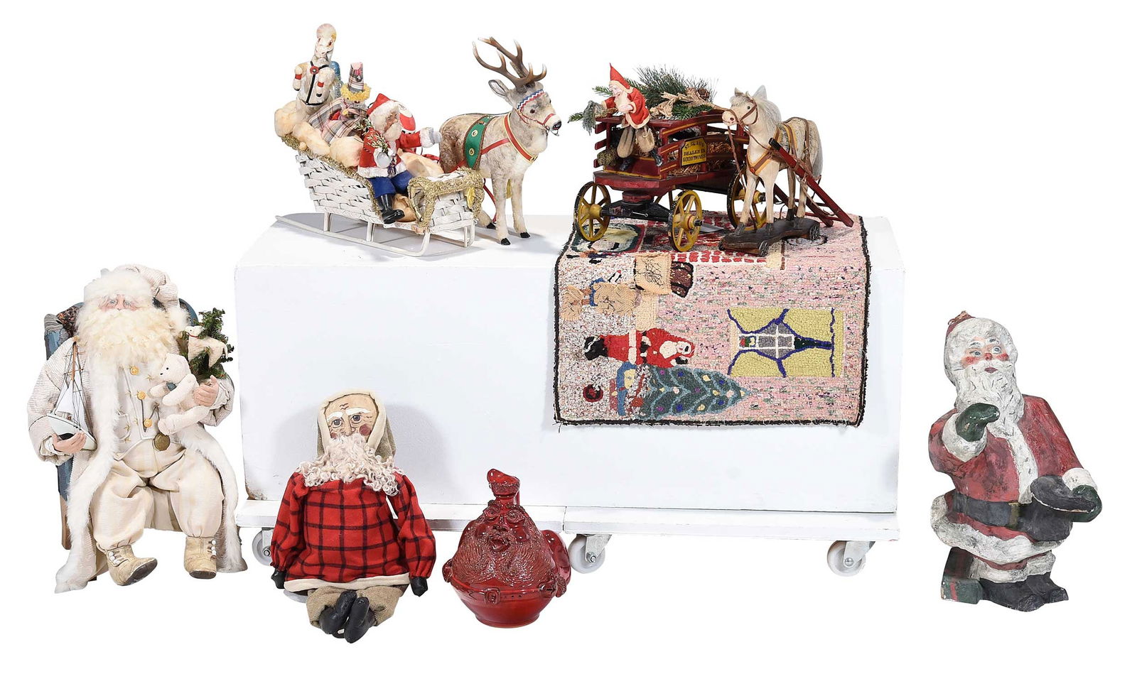 Collection of Seven American Folk Art Christmas Decorations: probably 20th century, comprising: Billy Ray Hussey (Robbins, North Carolina, born 1955) red Santa jug, inscribed "Merry Christmas 1992" and initialed "BH"; Bethany Lowe Santa Claus doll with