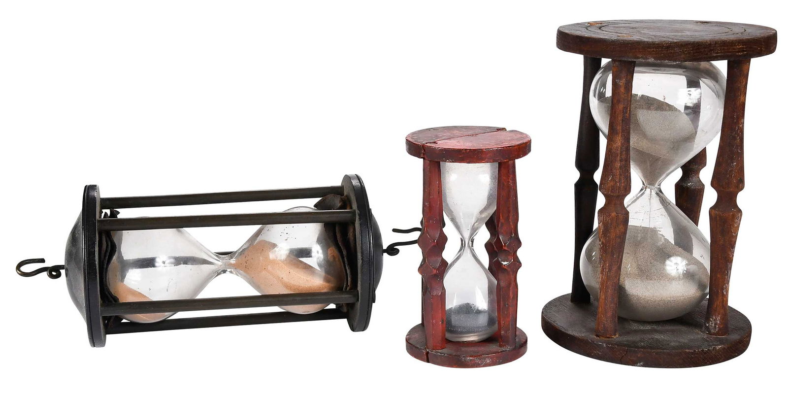 Three Early Hourglasses: possibly late 18th/early 19th century, varying woods, finishes, and sand, hanging example possibly made for use on a ship, largest 9-3/4 x 3-3/4 x 3-3/4 in.Provenance: The Ray J. and Anne K. Groves