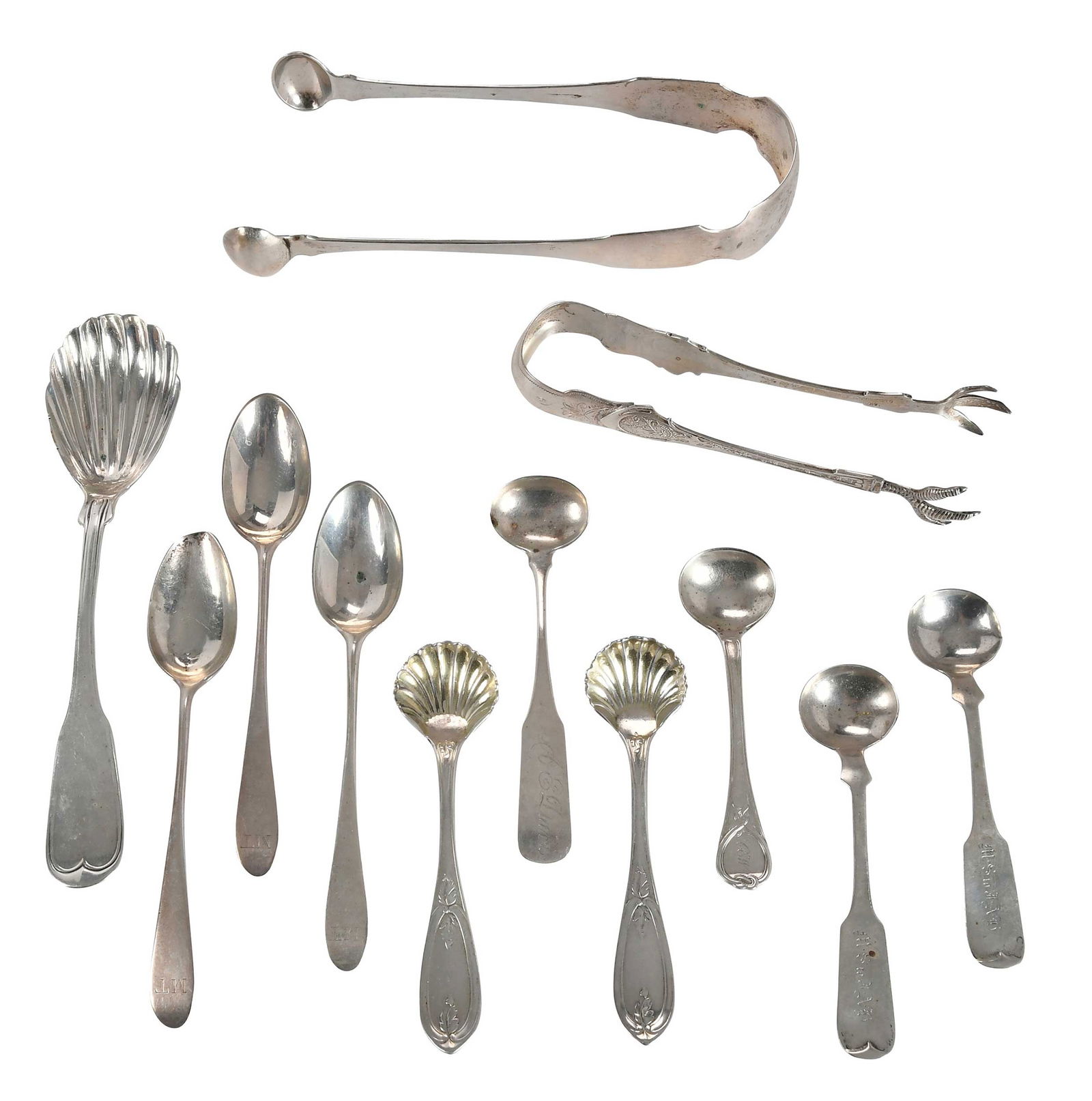 12 Pieces Northern Coin Silver Flatware: 19th century, including two sugar tongs; sugar spoon; salt spoons, some with shell bowl; three small early spoons, unmarked, most with monograms, various makers, 5.85 oz. T., 3-1/2 in. to 6-1/4