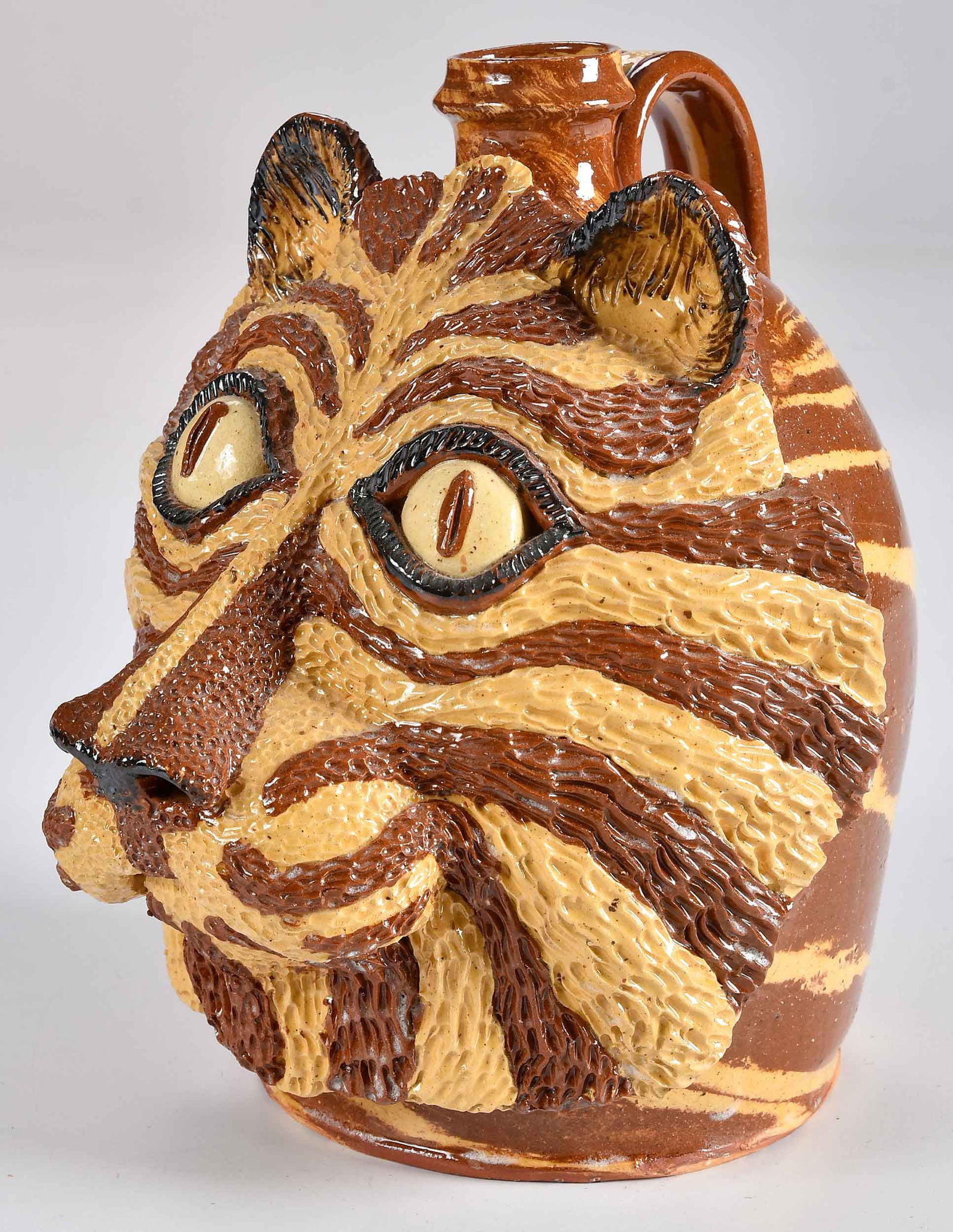 Billy Ray Hussey: (Robbins, North Carolina, born 1955)Tiger Face Jug, 1995, signed and inscribed to base "BH/Christmas/1995", ceramic, 9-1/4 x 7-5/8 x 8-1/2 in.Provenance: Private Collection, Georgetown, South Carolina