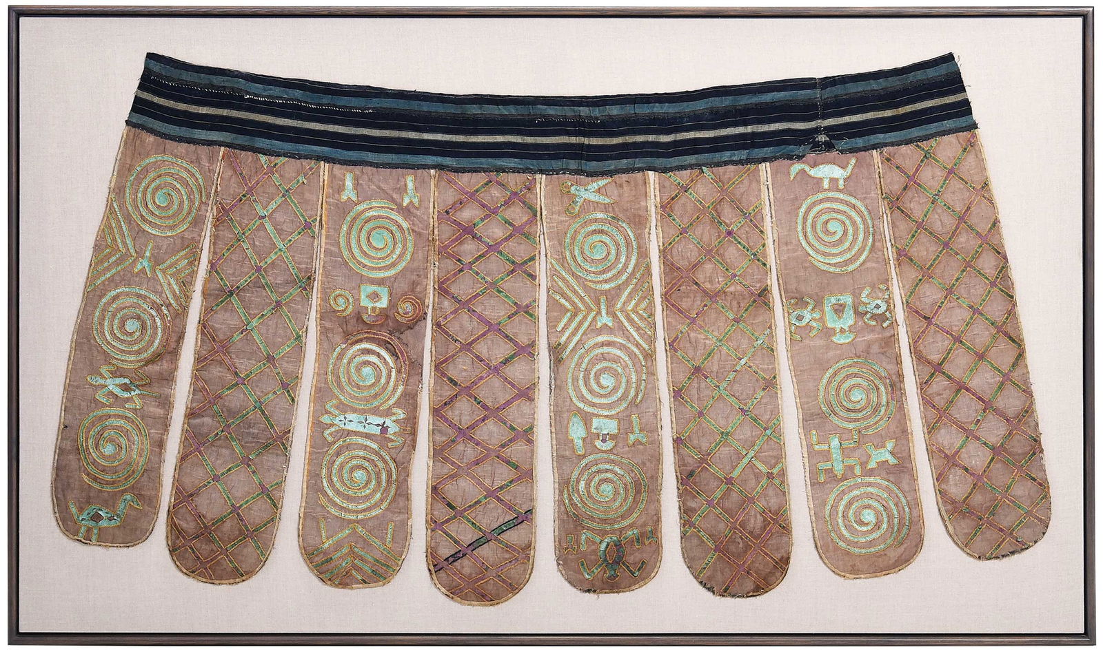 Nigerian Tribal Dance Apron: linen with leather applique, approx. 37 x 72 in.; laid on fabric mat in modern wood frame, approx. 47-1/4 x 80 x 2-1/2 in. Provenance: Douglas Dawson Gallery, Chicago, October 28, 1990, (accompanied b