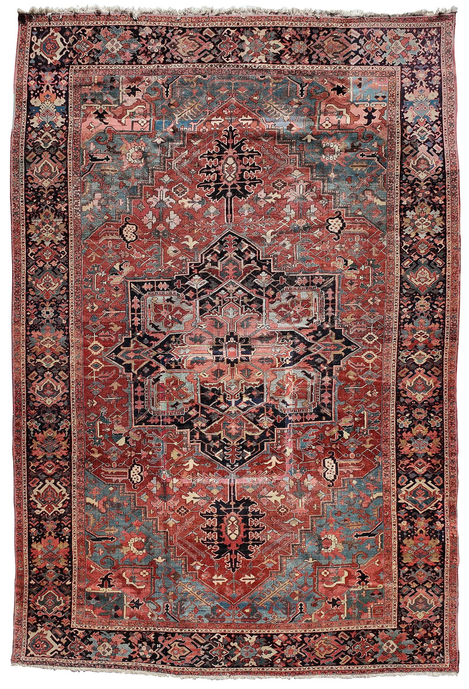Serapi Carpet: late 19th/early 20th century, central dark blue medallion on red ground, dark blue main border, 16 ft. 8 in. x 11 in. 