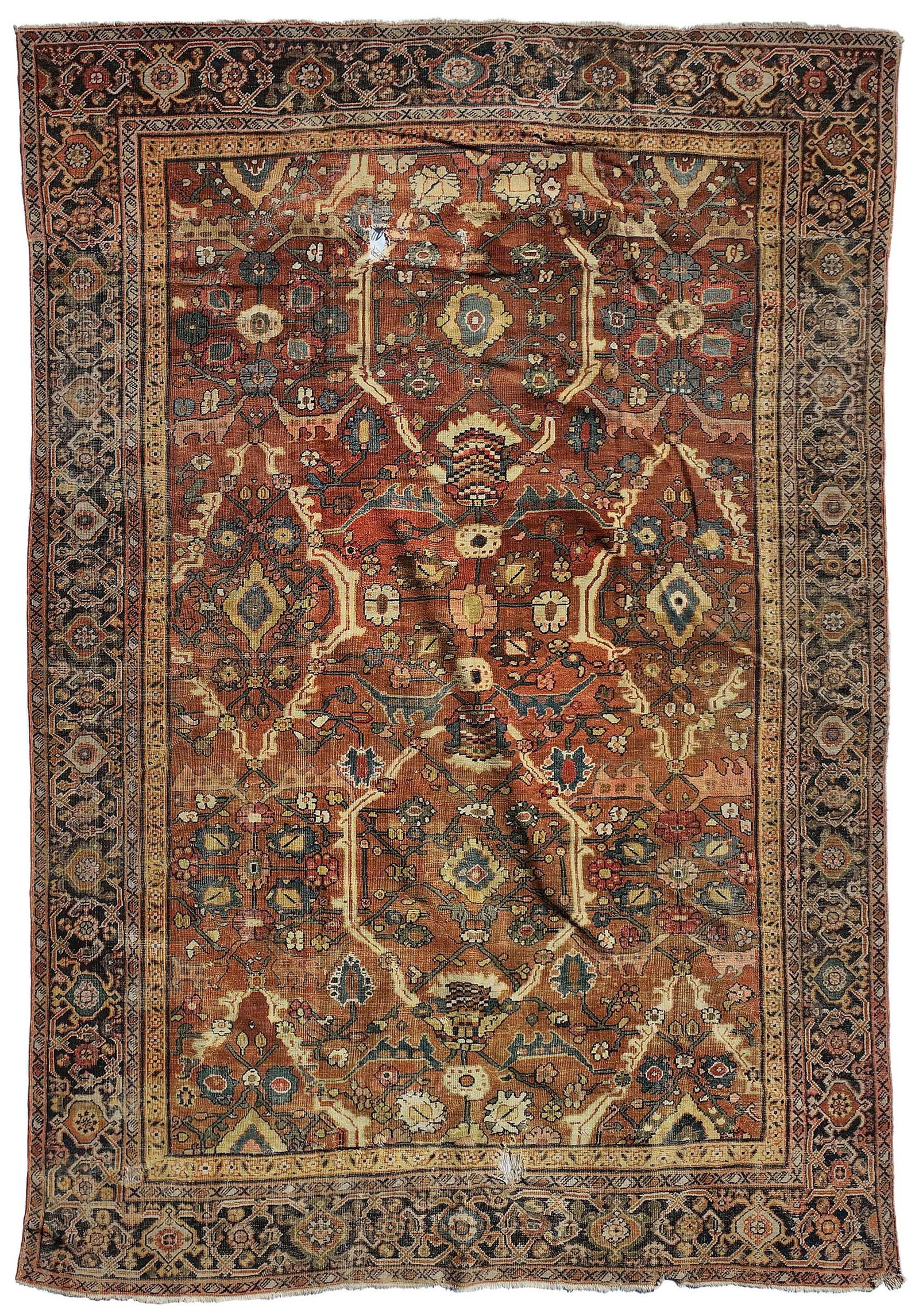 Bakshaish Carpet: floral and foliate motif on brick red ground, dark blue main border, 10 ft. 10 in. x 7 ft. 6 in. Provenance: Private Collection, Greenville, South Carolina