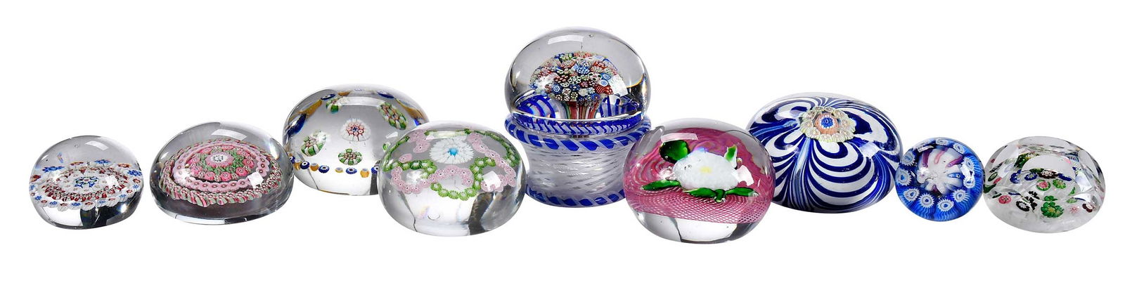 Eight Glass Paperweights and Glass Drawer Knob, Saint Louis and Baccarat: 20th century, varying sizes and forms, one example marked Baccarat to underside of base, white flower on pink ground of Saint Louis design, largest 3-1/2 x 3 x 3 in.Provenance: Irving Spanierman,