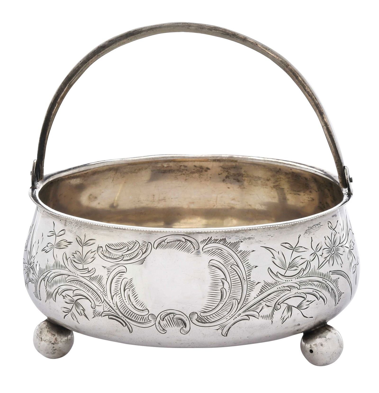 Russian Silver Sugar Basket: early 20th century, round with bail handle, ball feet, .875 fine, 6.30 oz. T., 4-3/4 x 5 x 5 in.Provenance: Private Collection, Asheville, North Carolina