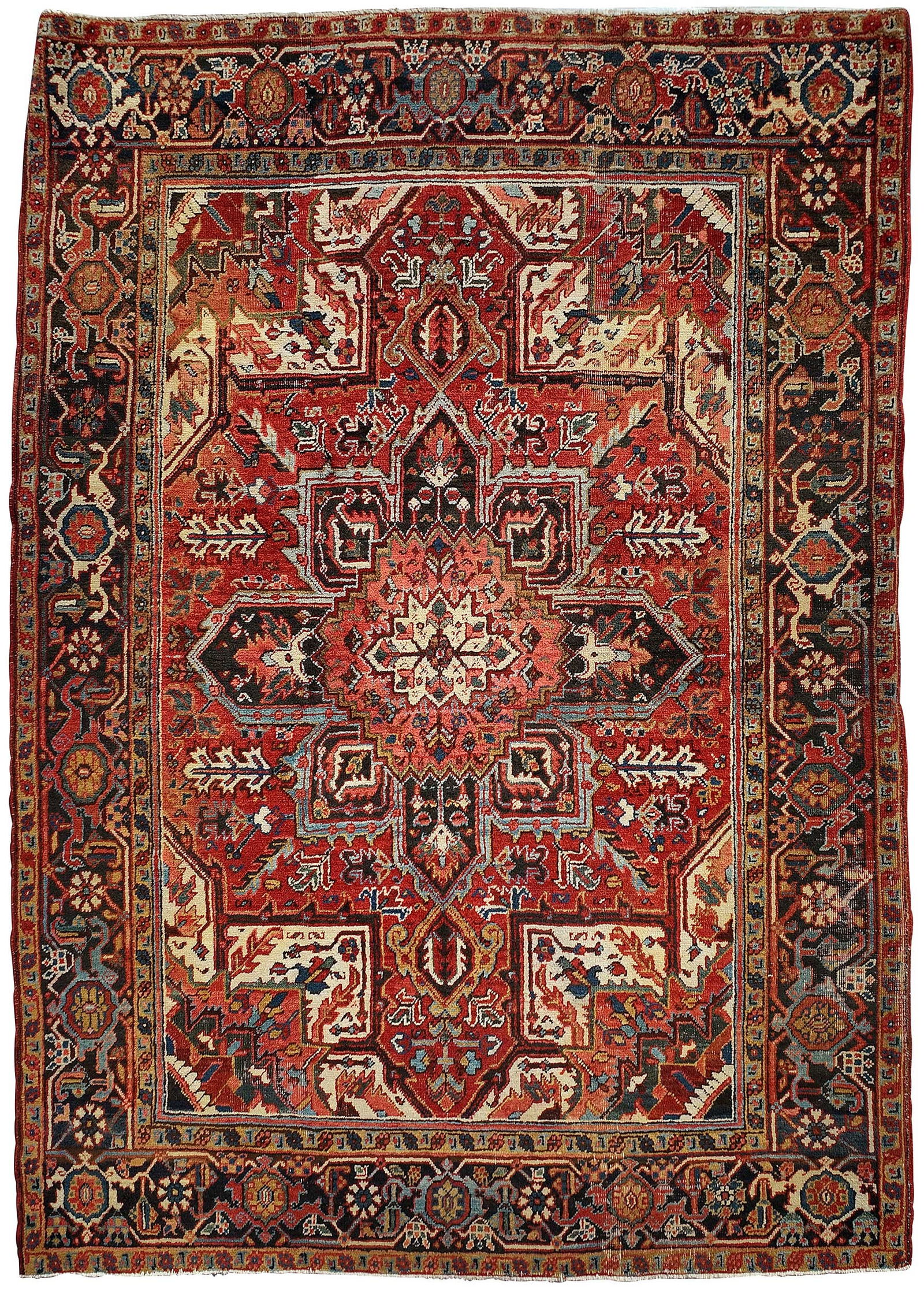 Heriz Carpet: central medallion on red ground, blue main border, 8 ft. x 5 ft. 11 in.Provenance: Private Collection