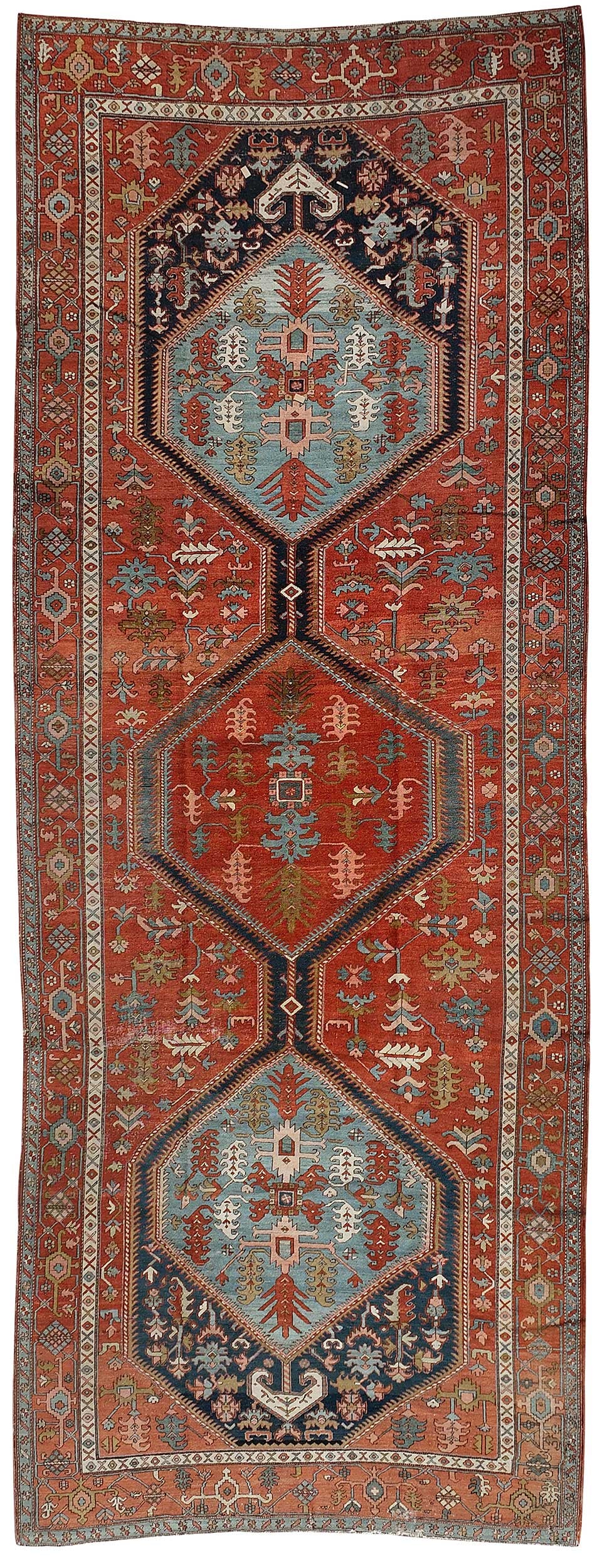 Serapi Gallery Carpet: early 20th century, three medallions, red main ground, red main border, 17 ft. 9 in. x 6 ft. 11 in. Provenance: Estate of Lamar John Ryan Cecil, Lynchburg, Virginia