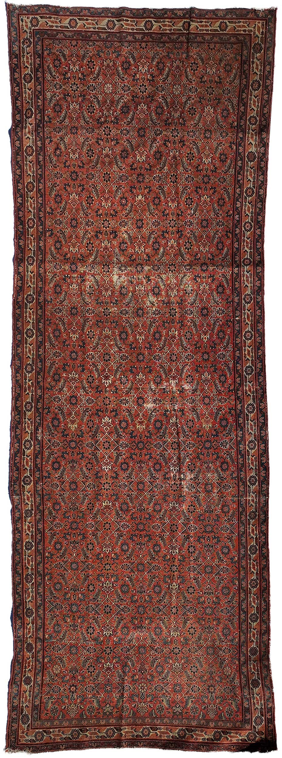 Persian Gallery Rug: early 20th century, geometric floral and foliate motif on red ground, cream main border, 12 ft. 5 in. x 4 ft. 6 in.Provenance: Private Collection, Greenville, South Carolina