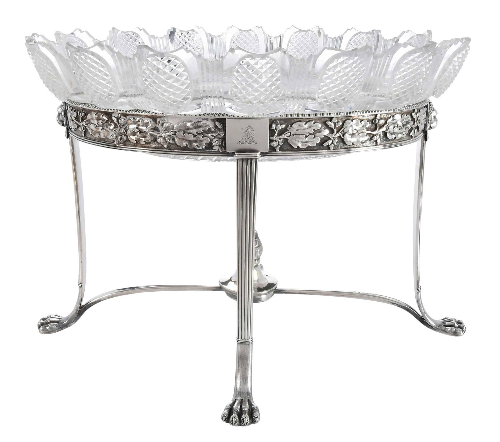 English Silver and Cut Glass Center Bowl: London, 1804, oval form with four paw feet, flame finial, crest on side band, maker probably William Stroud, 41.54 oz. T. excluding finial, oval cut glass bowl, 10 x 14-1/2 x 10-3/4 in.Provenance:
