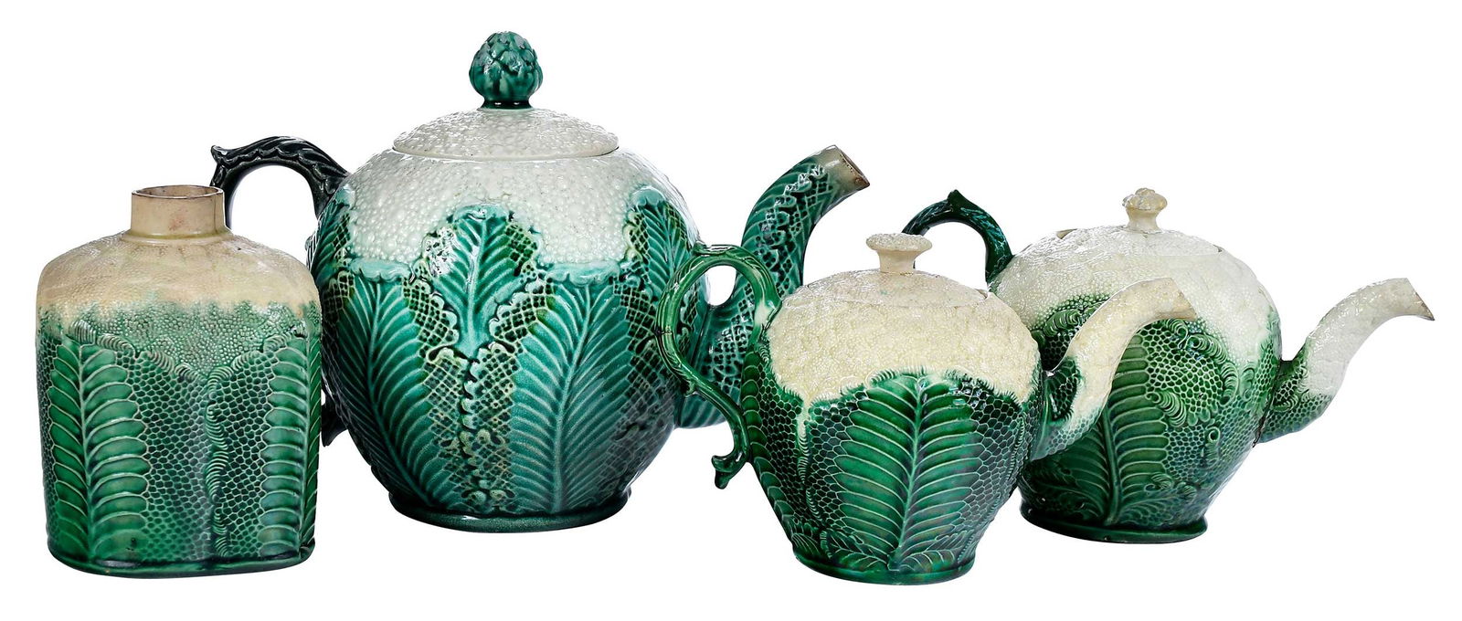 Four Staffordshire Cauliflower Tea Vessels: English, each with cream colored florets over green glazed leaves, comprising: three 18th century examples (two teapots, tea caddy); one later teapot; largest 7-1/2 x 10 x 5-1/2 in.Provenance: