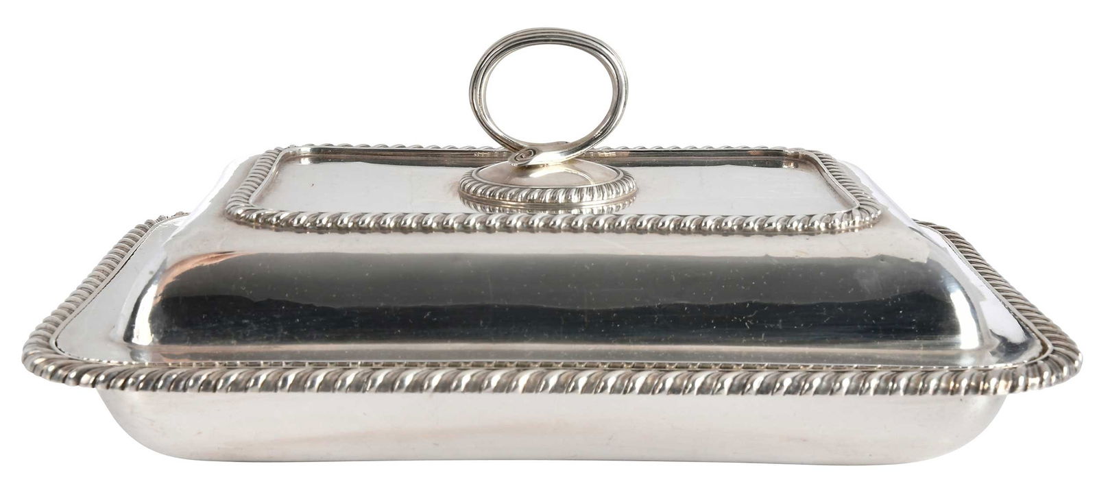 Georgian Style Sterling Covered Entree: 20th century, rounded rectangular with gadroon borders, interior monograms, no maker's marks, 49.19 oz. T., 4 x 8-1/4x 11-1/4 in.Provenance: Estate of Linda Sargent Thompson, Historic Sesame Lodge,