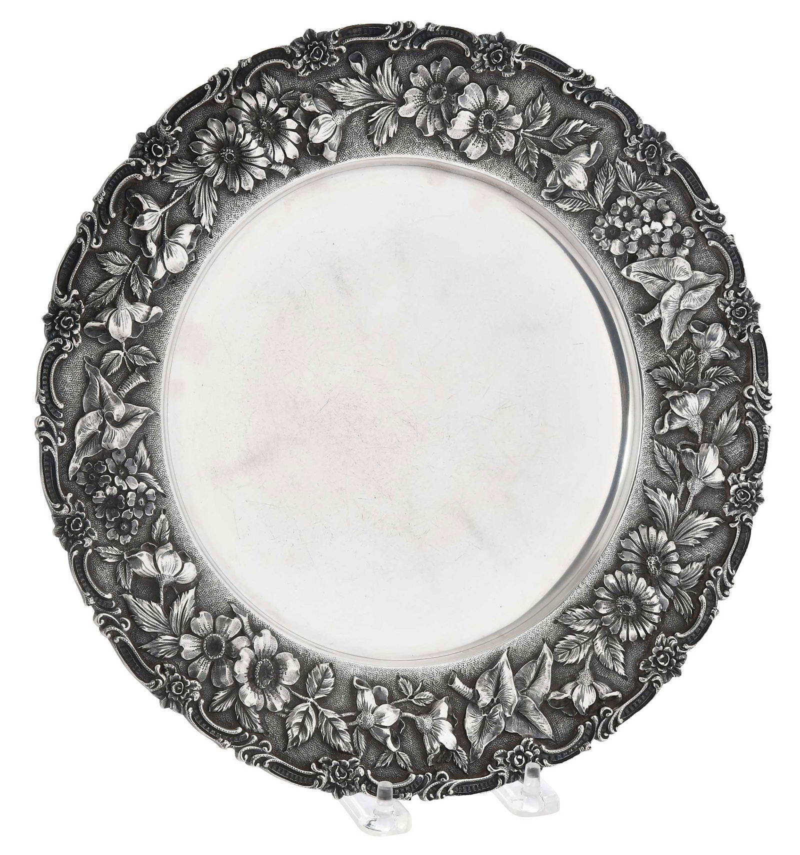 Kirk Repousse Sterling Plate: Baltimore, 1896-1924, round with floral repousse border, no monogram front, base inscribed "Father and Mother/on their silver wedding.." marks for S. Kirk & Son, 18.39 oz. T., 11 in.Provenance: