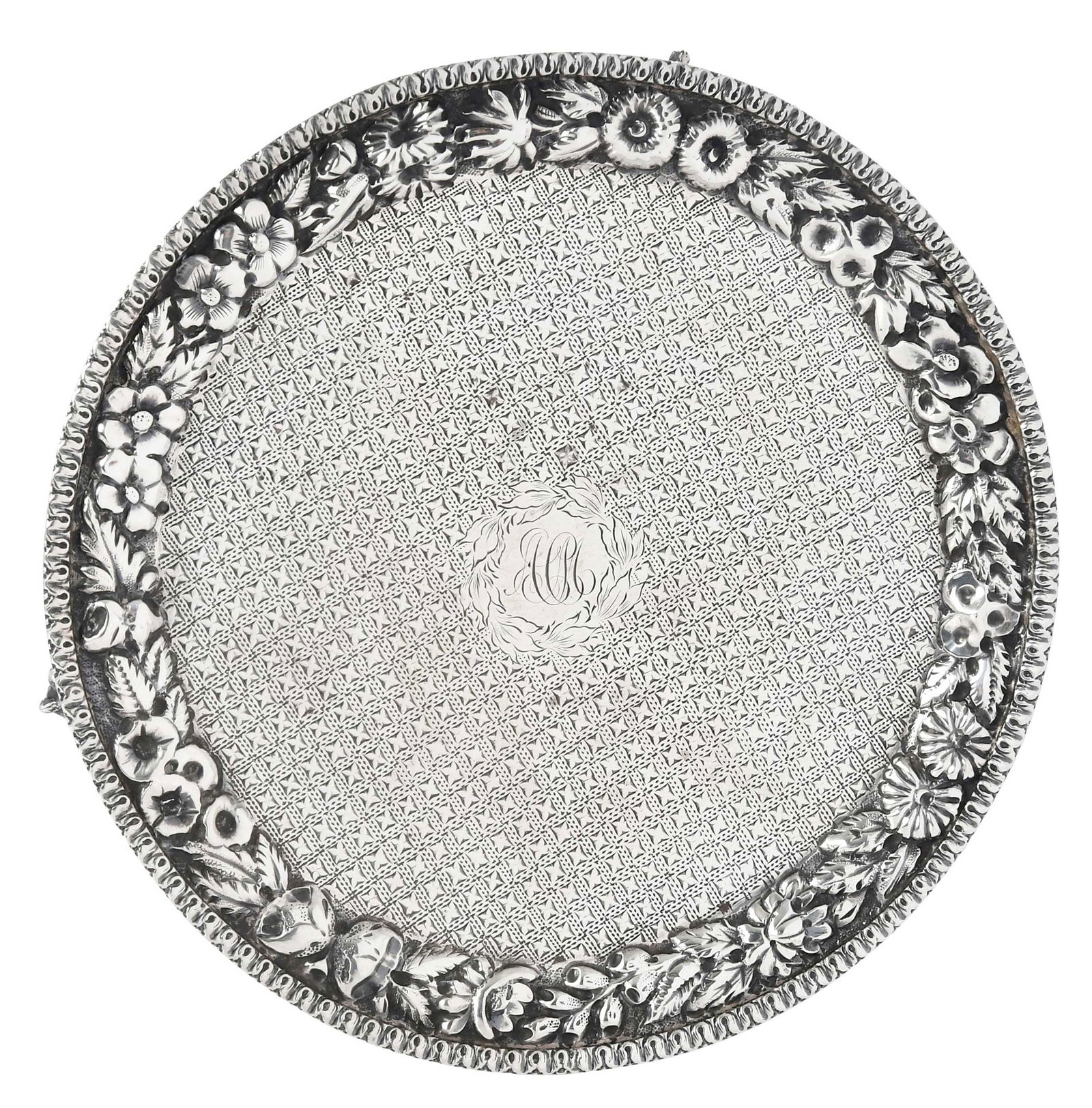 Kirk Repousse Coin Silver Footed Salver: Baltimore, 1868-1890, round with floral repousse border, central cartouche monogram, back monogram "A.C.M./Christmas./1888", marks for S. Kirk & Son, 5.08 oz. T., 1 x 6-1/2 in.Provenance: Irving