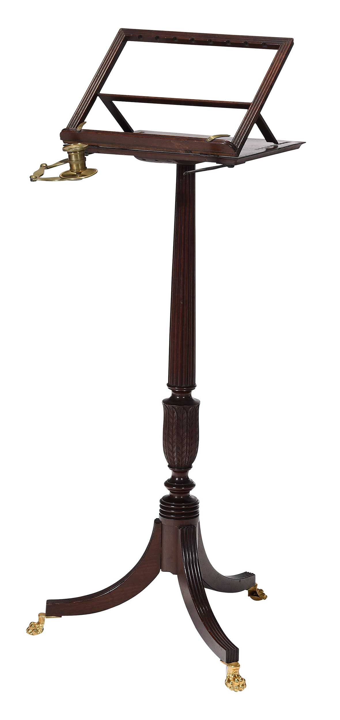 Rare American Classical Mahogany Adjustable Music Stand Amory Haskell Provenance: attributed to New York, early 19th century, brass clips, hinged candle-arm and casters, reeded and leaf carving, underside with paper label inscribed "Property of Mrs. J. Amory Haskell", 38 × 18