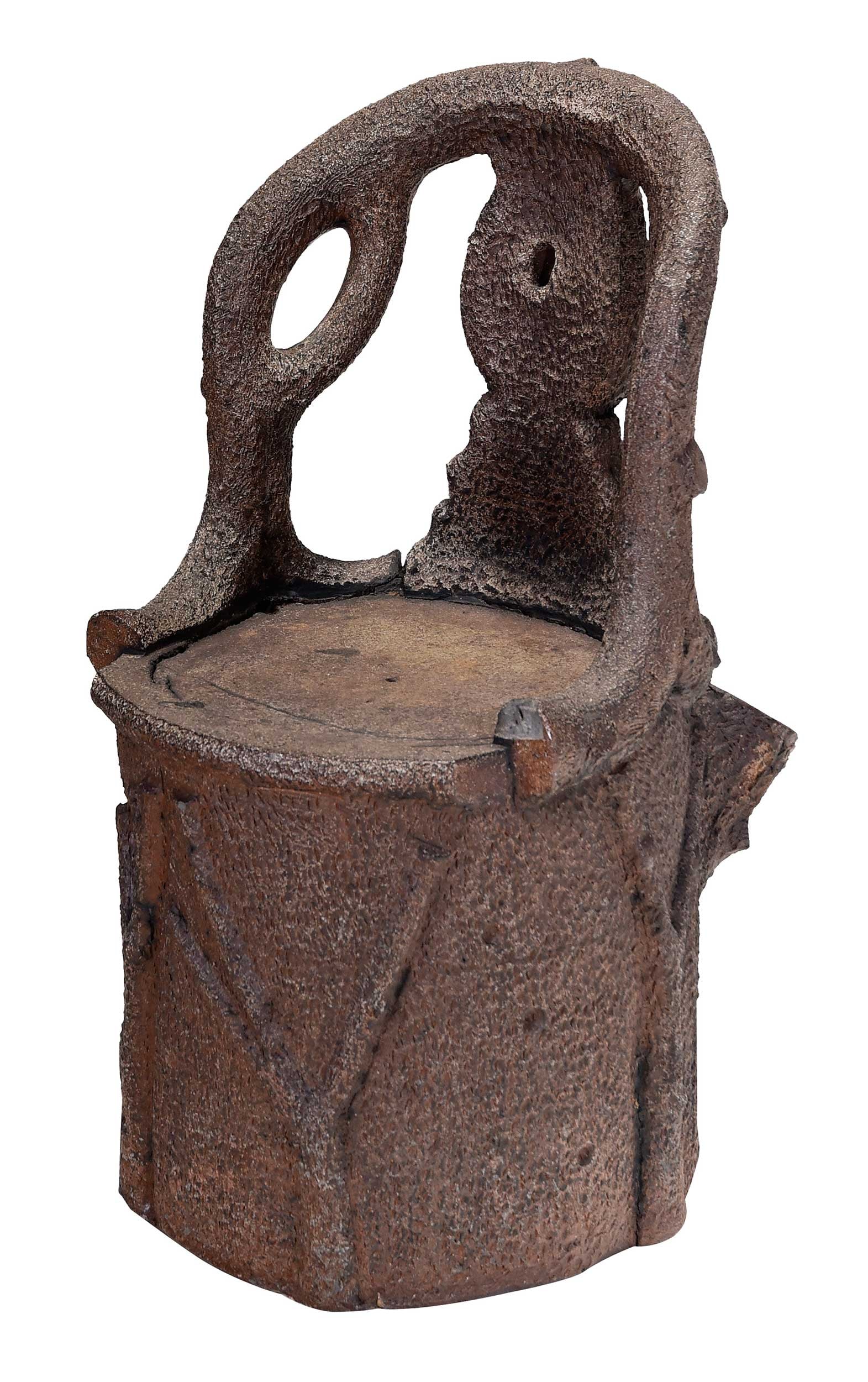 Unusual Cast Faux Bois Garden Seat: Late 19th/early 20th century, possibly cast lead with an applied finish, possibly unique, the unusual stump form base with cast faux bois back, two openings simulating branches at back of stump,