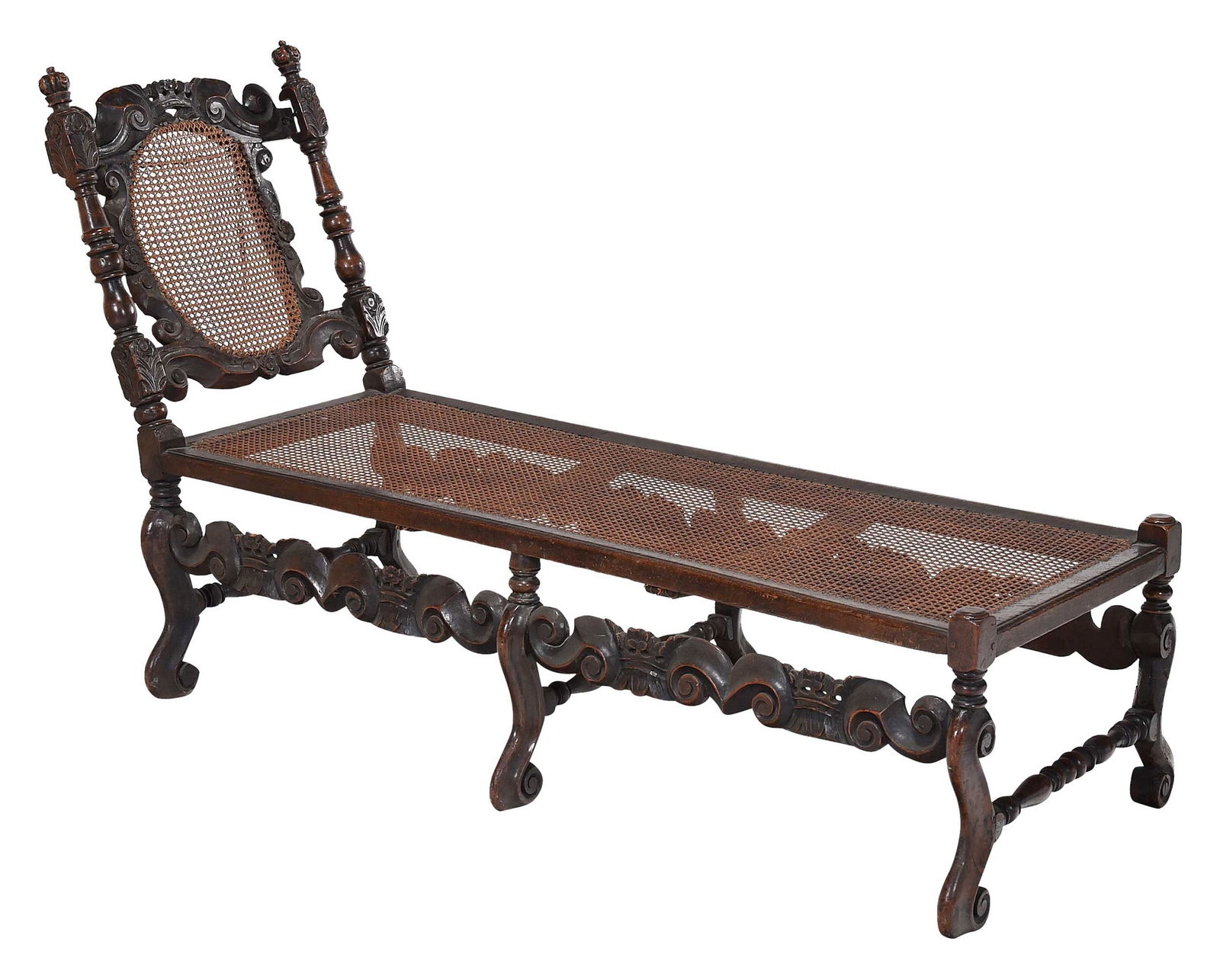 William and Mary Carved Walnut Caned Daybed: British, circa 1690, heavily carved walnut frame with crown to crest rail, scrolled and crowned skirt rails, caned back and seat, back angle adjustable, 38-1/4 x 25-1/4 x 68 in.Provenance: Gift of