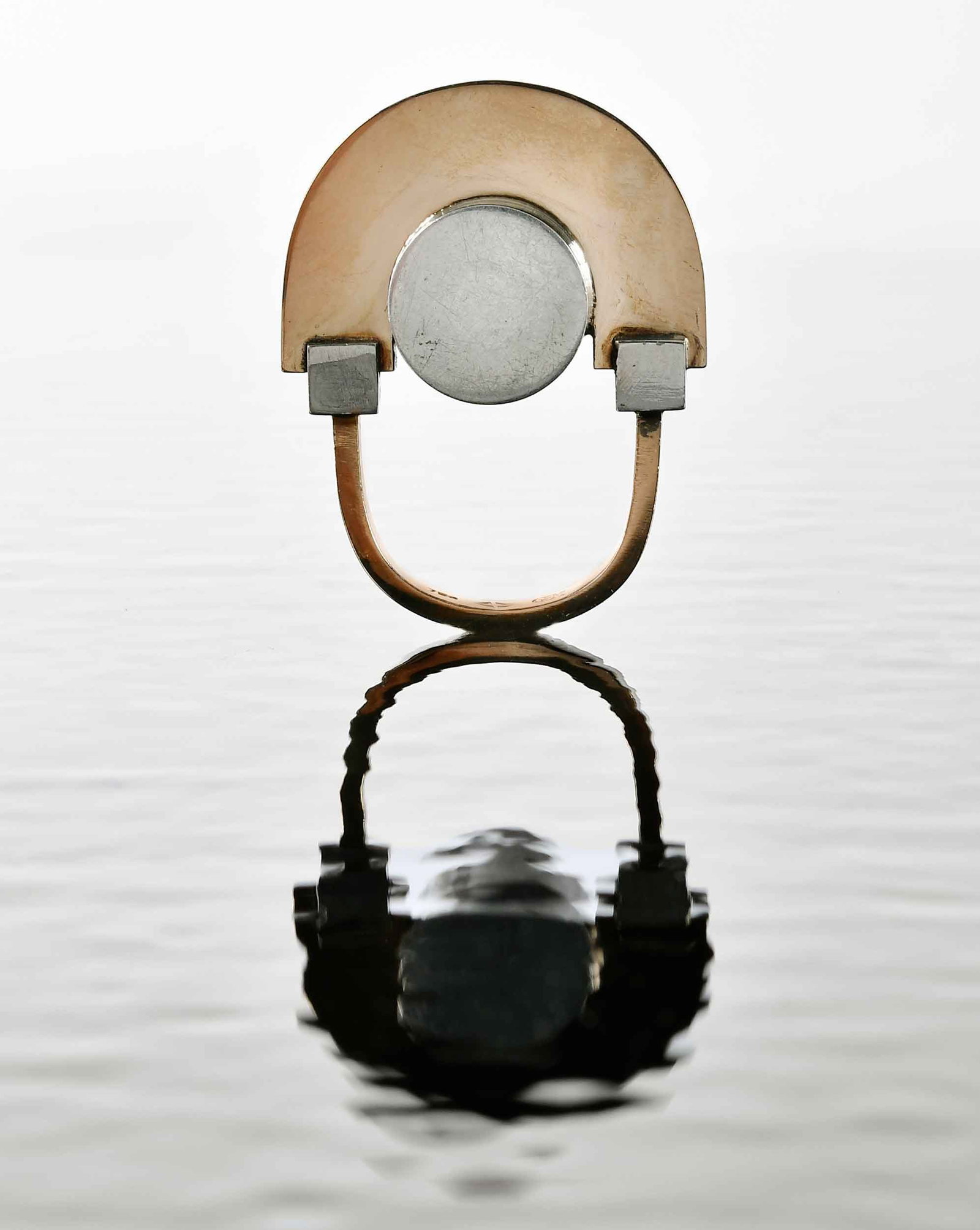 18kt. and Silver Arnaldo Pomodoro Gem Montebello Ring: circa 1967, architectural design, center silver cylinder topped with an 18kt. yellow gold arch, marked "750, GEM", with makers mark, 8 ring sz., 18.7gProvenance: Private Collection, Asheville, North