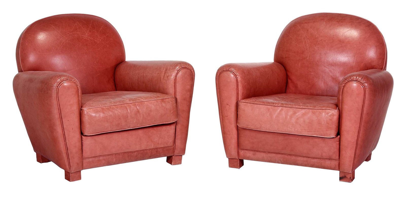Pair of Poltrona Frau Attributed Art Deco Style Red Leather Club Chairs: 20th century, arched back, thick rounded arms, short block feet, red upholstery with attractive patina, 34 x 37 x 35 in., seat height 17 in. Provenance: Private Collection, Flat Rock, North Carolina