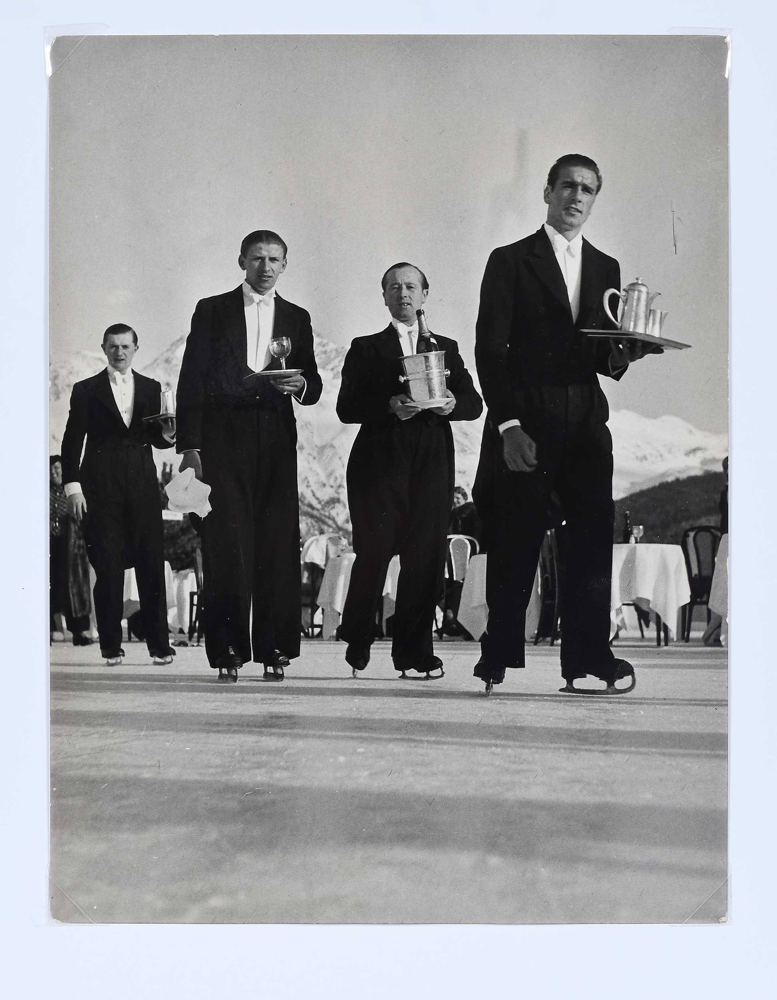 Alfred Eisenstaedt: (German/America, 1898-1995)Untitled (Skating Waiters, St. Moritz), 1934, stamped verso "Foto Blau/H. Niedecken/St. Moritz", inscribed in pencil verso "St. Moritz", gelatin silver print, 9-1/2 x 7-1/4