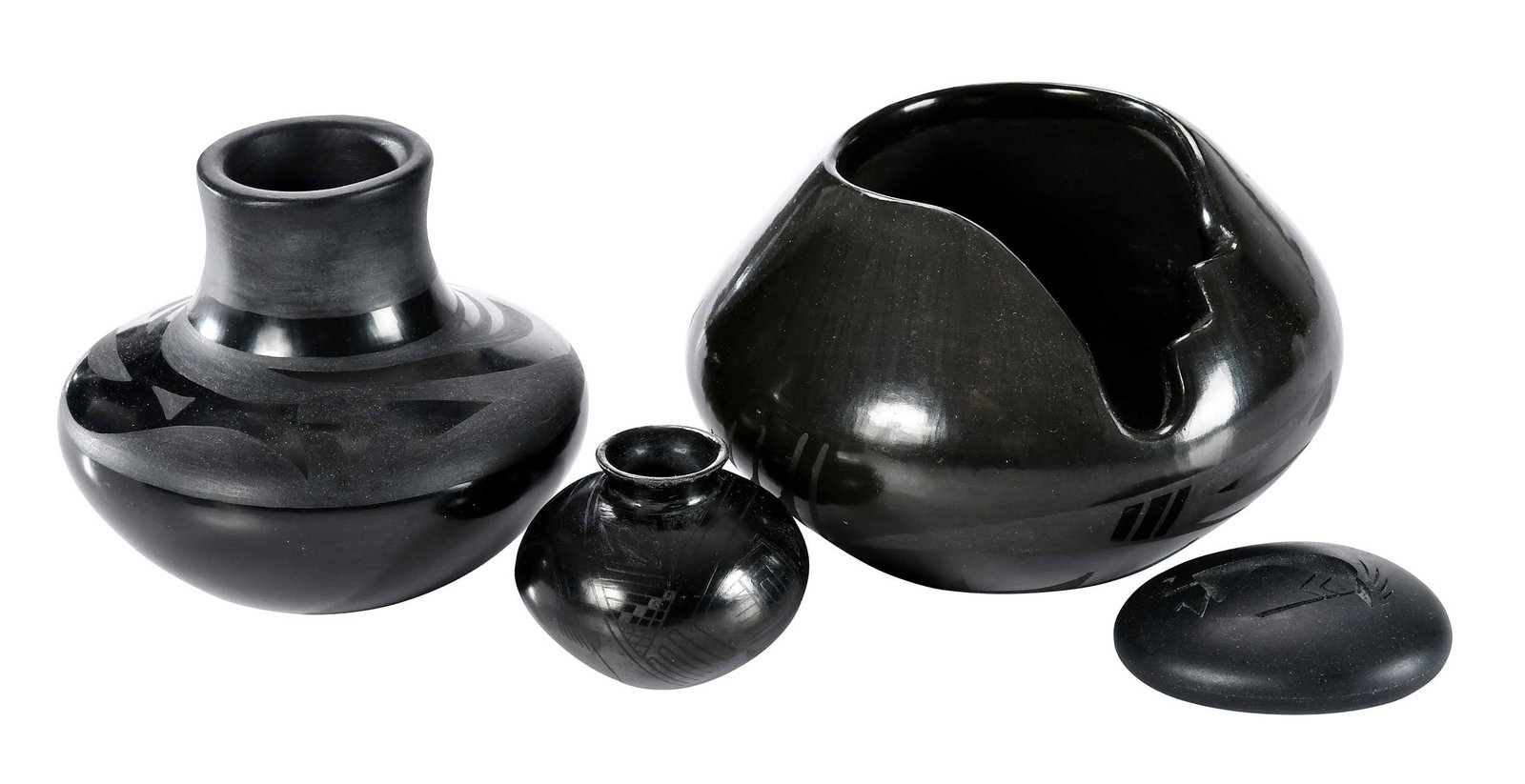 Black Ware from San Ildefonso, Mata Ortiz and More: four blackware items, the largest a black on black pot with cut out edge, signed on base "83 Cynthia Starflower San Ildefonso Pueblo", (Cynthia Starflower Dunlap, born 1959), 4-1/4 x 6-1/2 in.; togeth