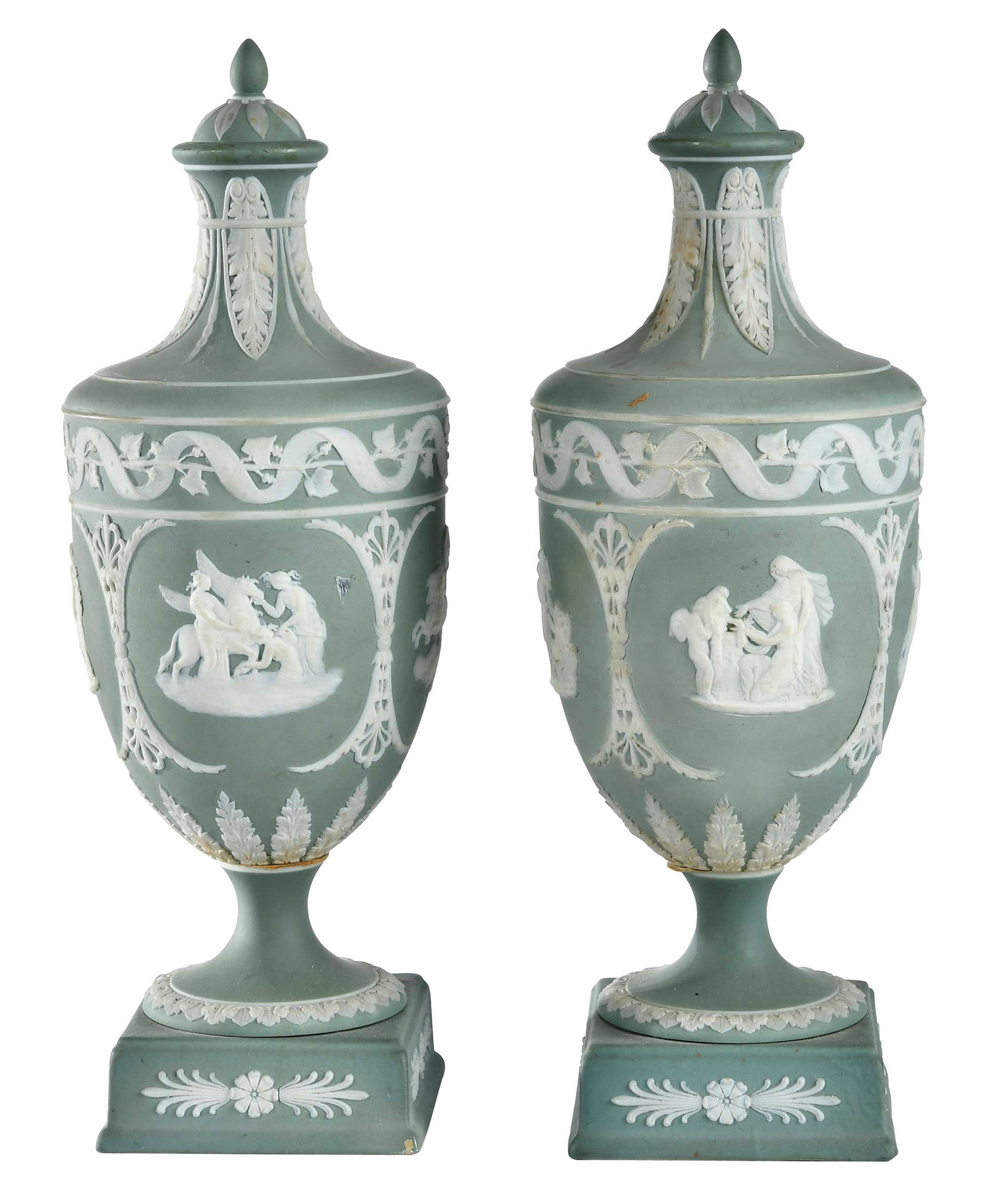 Pair of Wedgewood Sage Green Jasperware Urns: British, late 19th/early 20th century, stamped "Wedgwood" on bases, cameo floral and neoclassical motifs, 11-1/4 x 4 x 4 in. Provenance: Estate of Lamar John Ryan Cecil, Lynchburg, Virginia