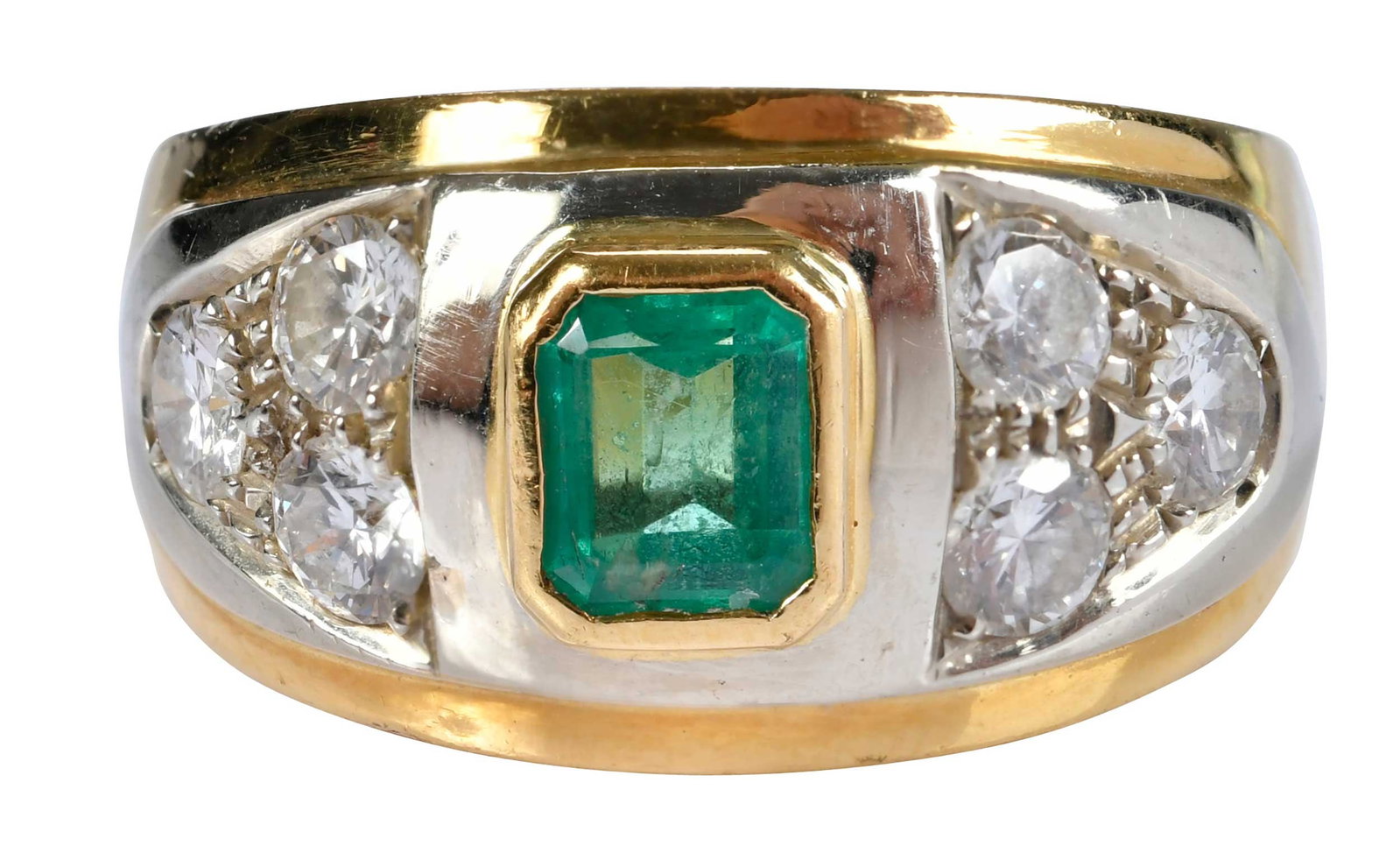 18kt. Two Tone Emerald and Diamond Cigar Style Band: emerald cut emerald, approx. 0.65ct., six round faceted diamonds, approx. 1.00ctw., VS, G-H, marked "750, 187 NA", yellow gold, 9 rings sz., 11.1 g Provenance: Private Collection, Virginia Beach Note: