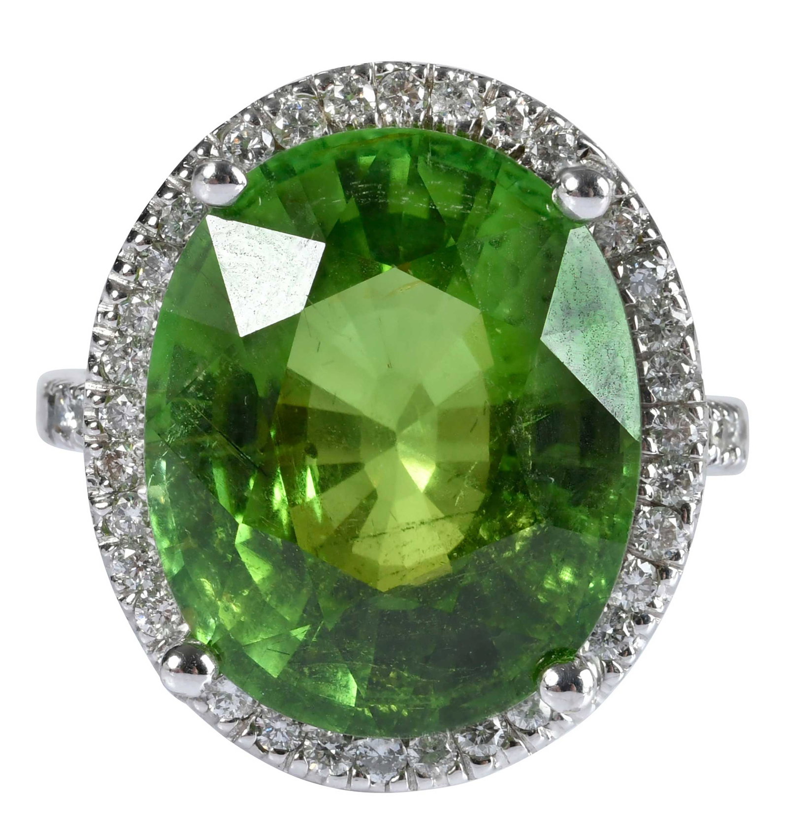18kt. Rare Green Tourmaline and Diamond Halo Ring: oval mixed cut green tourmaline, approx. 17.00ct., 42 round faceted diamonds, approx. 0.70ctw., marked "18K", white gold, 8 ring sz., 14.3 g Provenance: Private Collection, Virginia Beach Note: Accomp