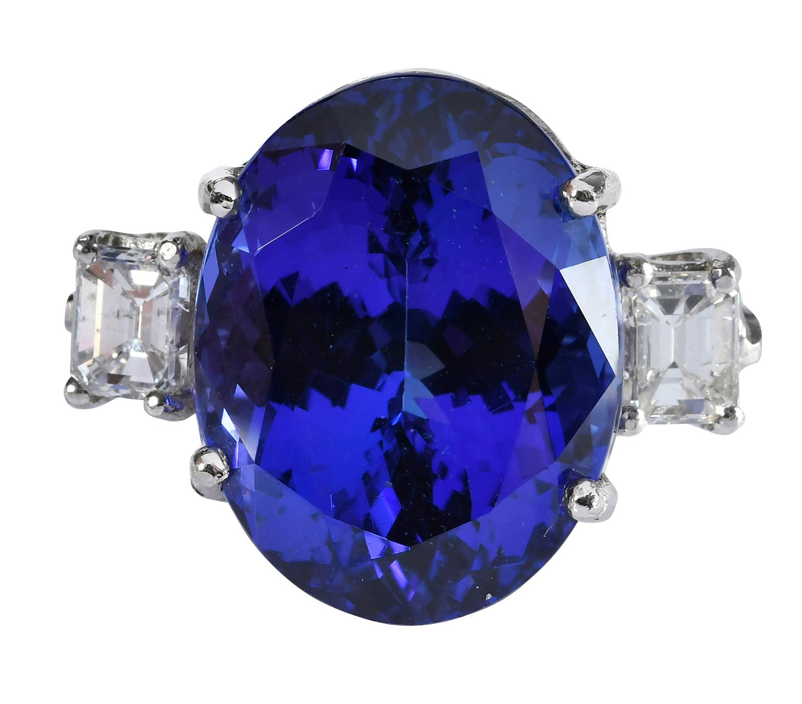Impressive Platinum Tanzanite and Diamond Ring: center oval faceted tanzinite, approx. 25.00ct., two emerald cut diamonds, approx. 0.60ctw., SI, H-I, marked "PLAT, 950", platinum, 8-3/4 ring sz., 22.5 g Provenance: Private Collection, Virginia Beac