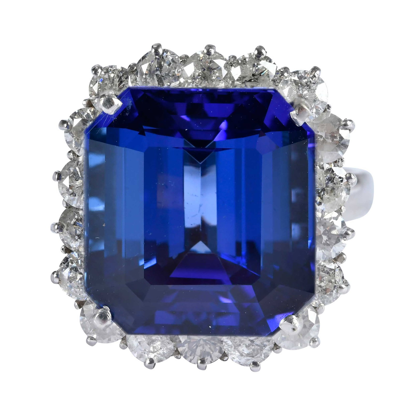 18kt. Tanzanite and Diamond Halo Ring: center emerald cut tanzanite, approx. 27.40ct., 18 round faceted cut diamonds, approx. 1.80ctw., SI-I, H-I, marked "18k", white gold, 9 ring sz., 14.2 g Provenance: Private Collection, Virginia Beach 