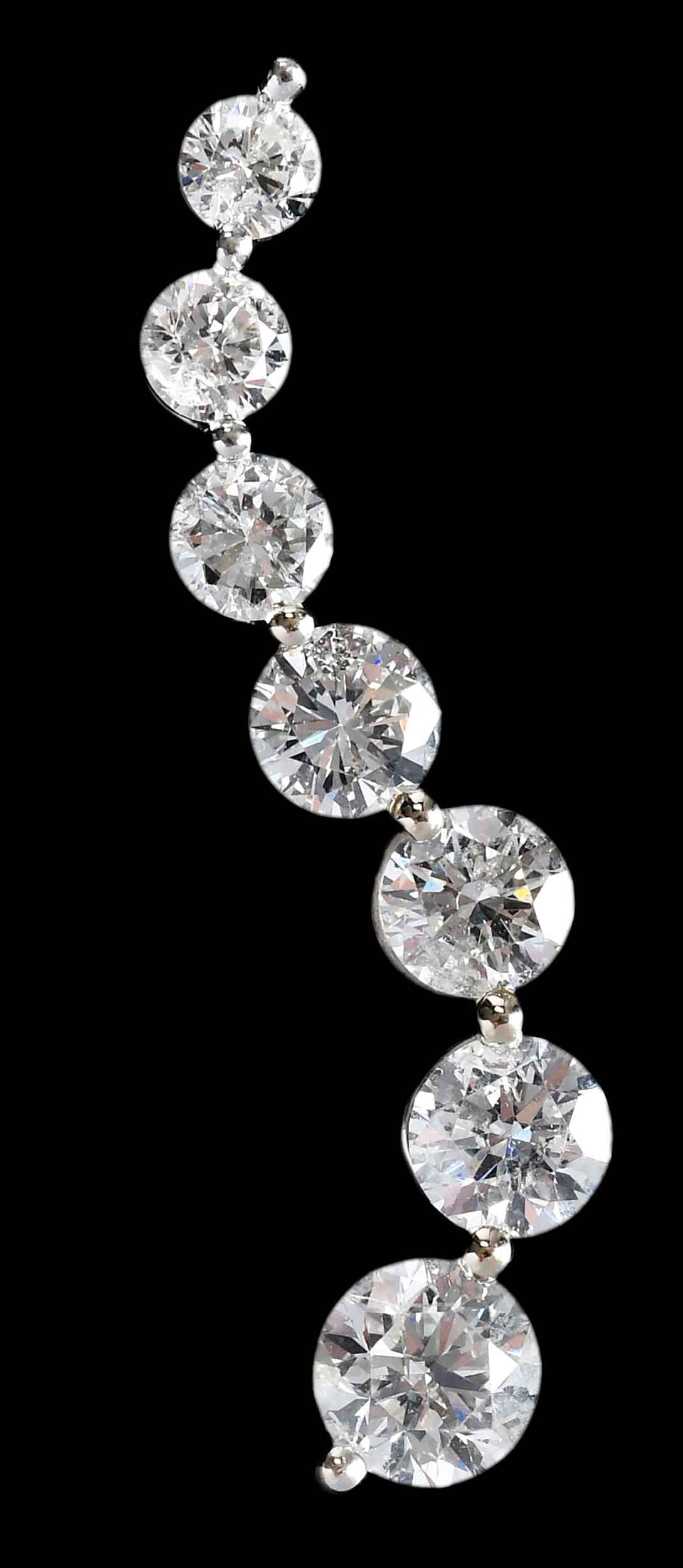 14kt. Diamond Trail Pendant: seven round faceted diamonds, graduating in size, approx. 0.75ct. - 0.17ct., 2.70ctw., SI-I, H-I, marked "14K, ZEI", white gold, 1-3/8 in. length, 2.9 g Provenance: Private Collection, Virginia Beach 