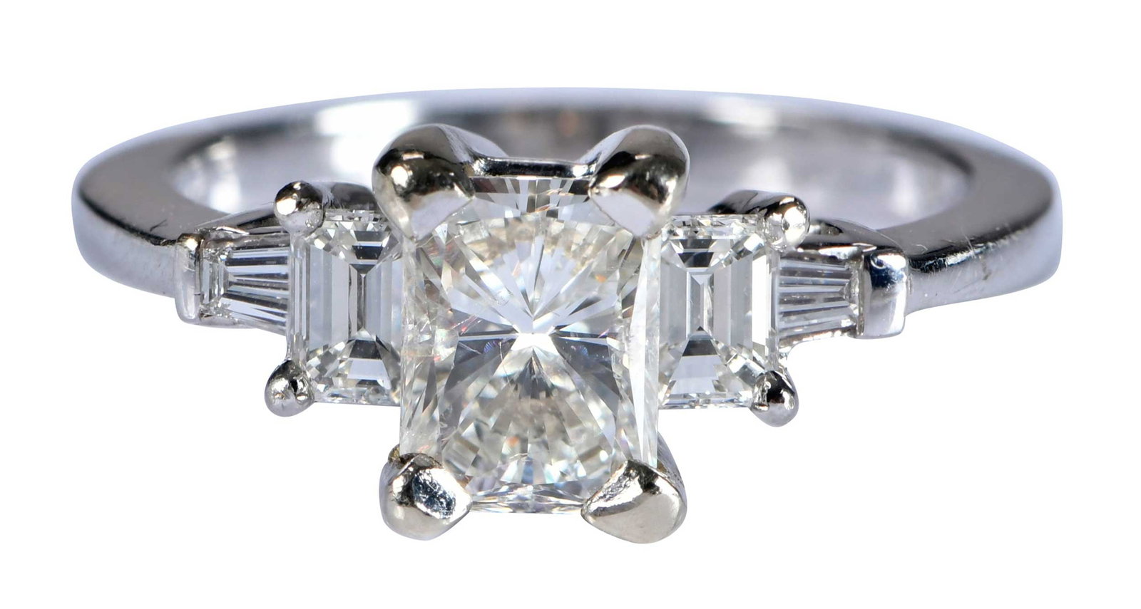 14kt. Radiant Diamond Ring: radiant modified cut diamond, approx. 1.35ct., I, I-J, flanked by two step emerald cut diamonds, and two tapered baguette cut diamonds, marked "S, 14K", white gold, 6 -1/2 rings sz., 4.3 g Provenance: