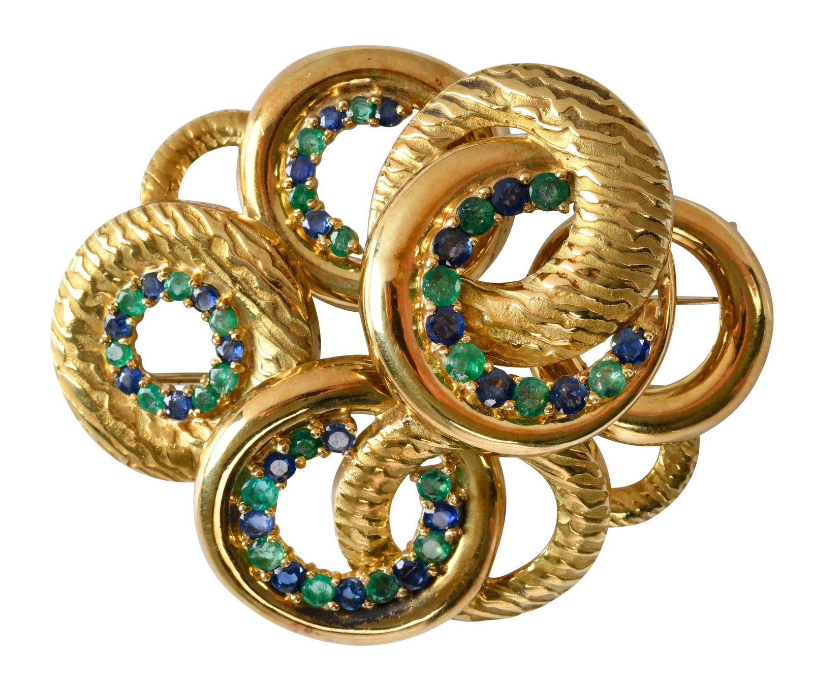 18kt. Large MCM Style Blue Sapphire and Emerald Brooch: round faceted blue sapphires and emeralds, graduating size, marked "ITALY, 18K, 796AL", yellow gold, textured and high polish finish, 2-3/8 in. x 2 in., fur clip, 22.2 g Provenance: Private collection