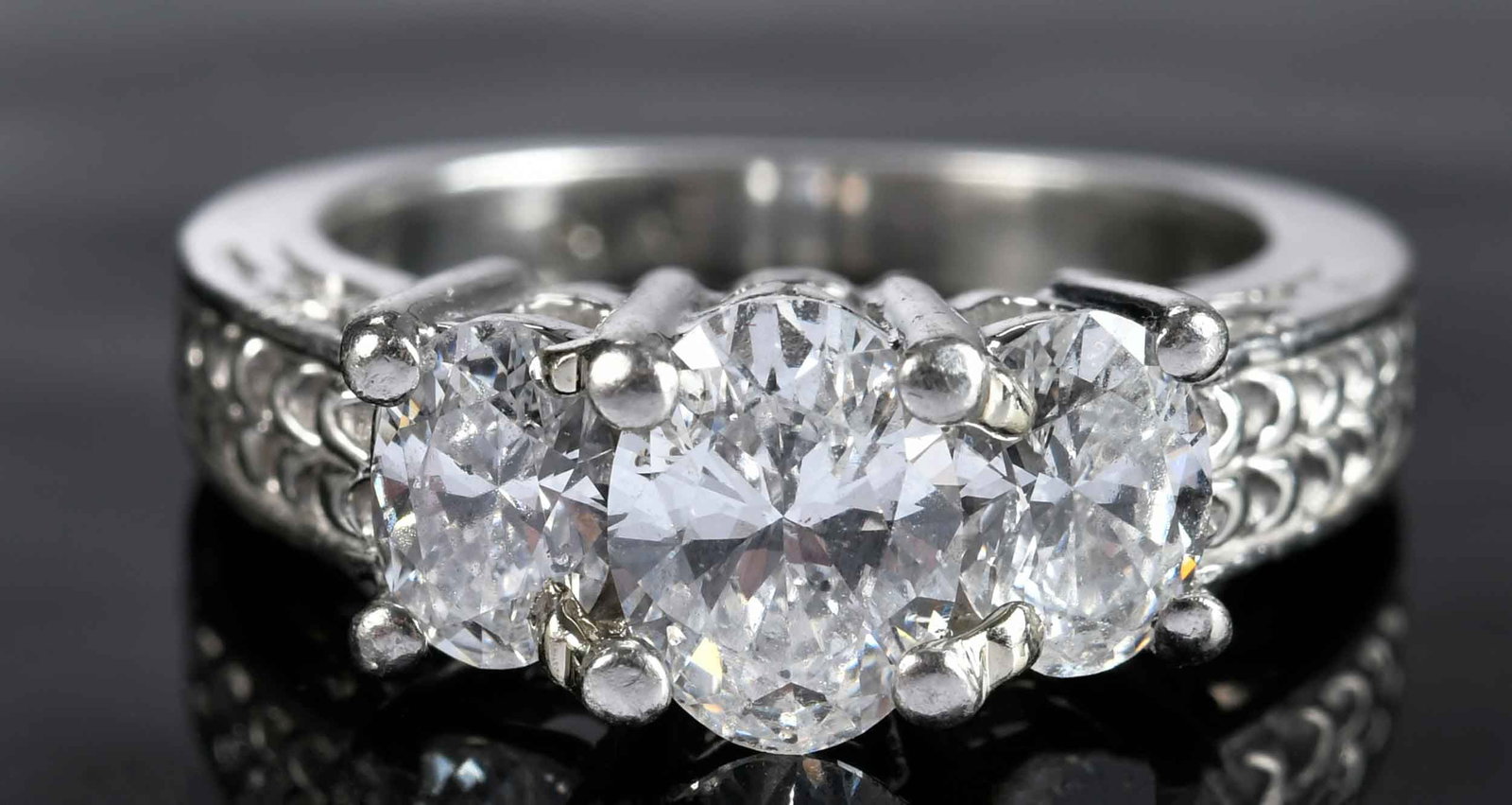 Platinum Three Stone Diamond Ring - GIA: center oval brilliant cut diamond, approx. 0.76ct., SI, D-E, flanked by two oval brilliant cut diamonds, approx. 0.71ctw., SI, D-E, GIA # AHXLD, marked "PLAT", 4 ring sz., 7.5 g Provenance: Private Vi
