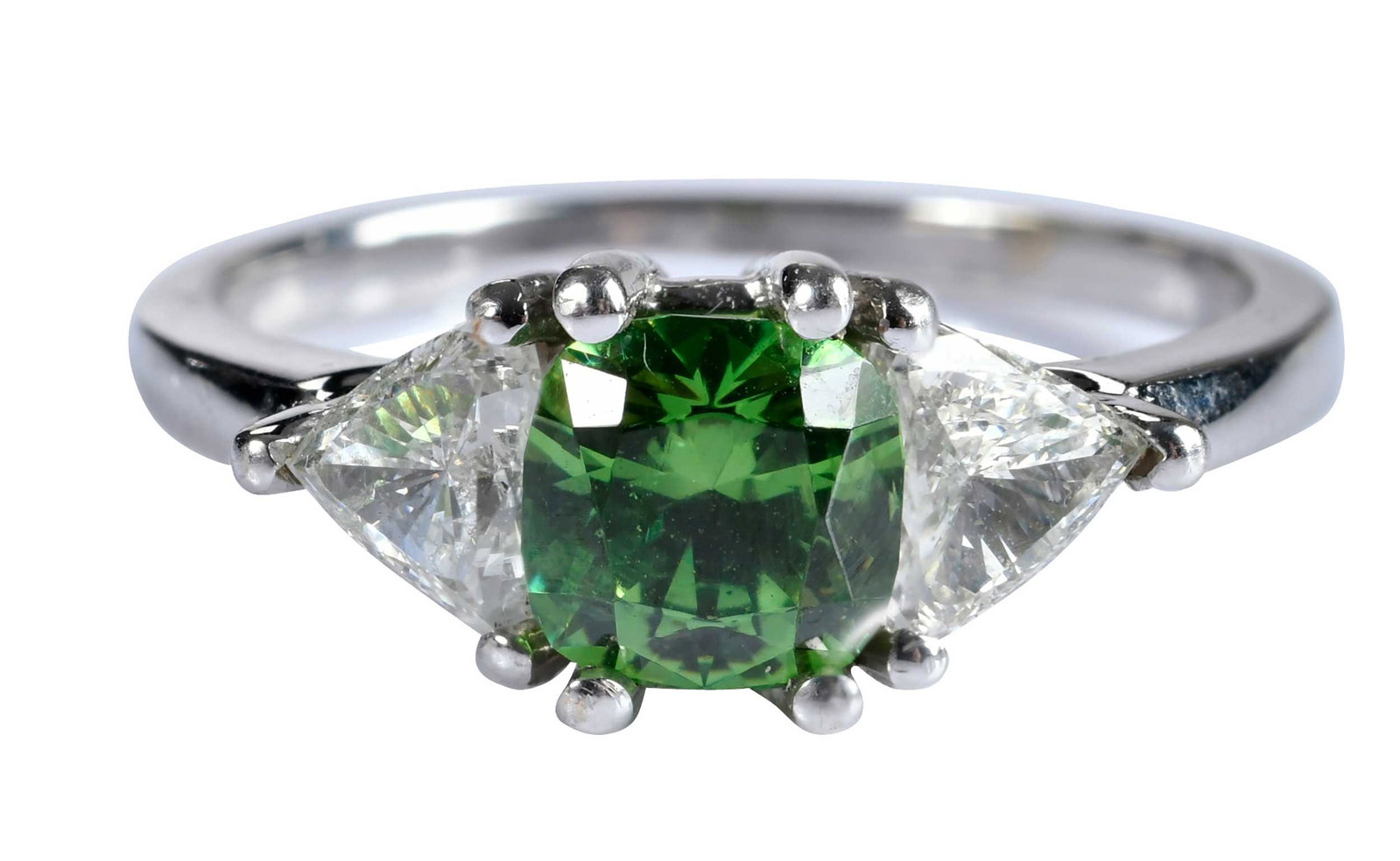 18kt. Demantoid Garnet and Trillion Diamond Ring: modified square cushion cut demantoid garnet, approx. 1.25ct., flanked by two triangle cut diamonds, approx. 0.75ctw., VS, G-H, marked "18K", white gold, 8 ring sz., 3.9 g Provenance: Private Collecti