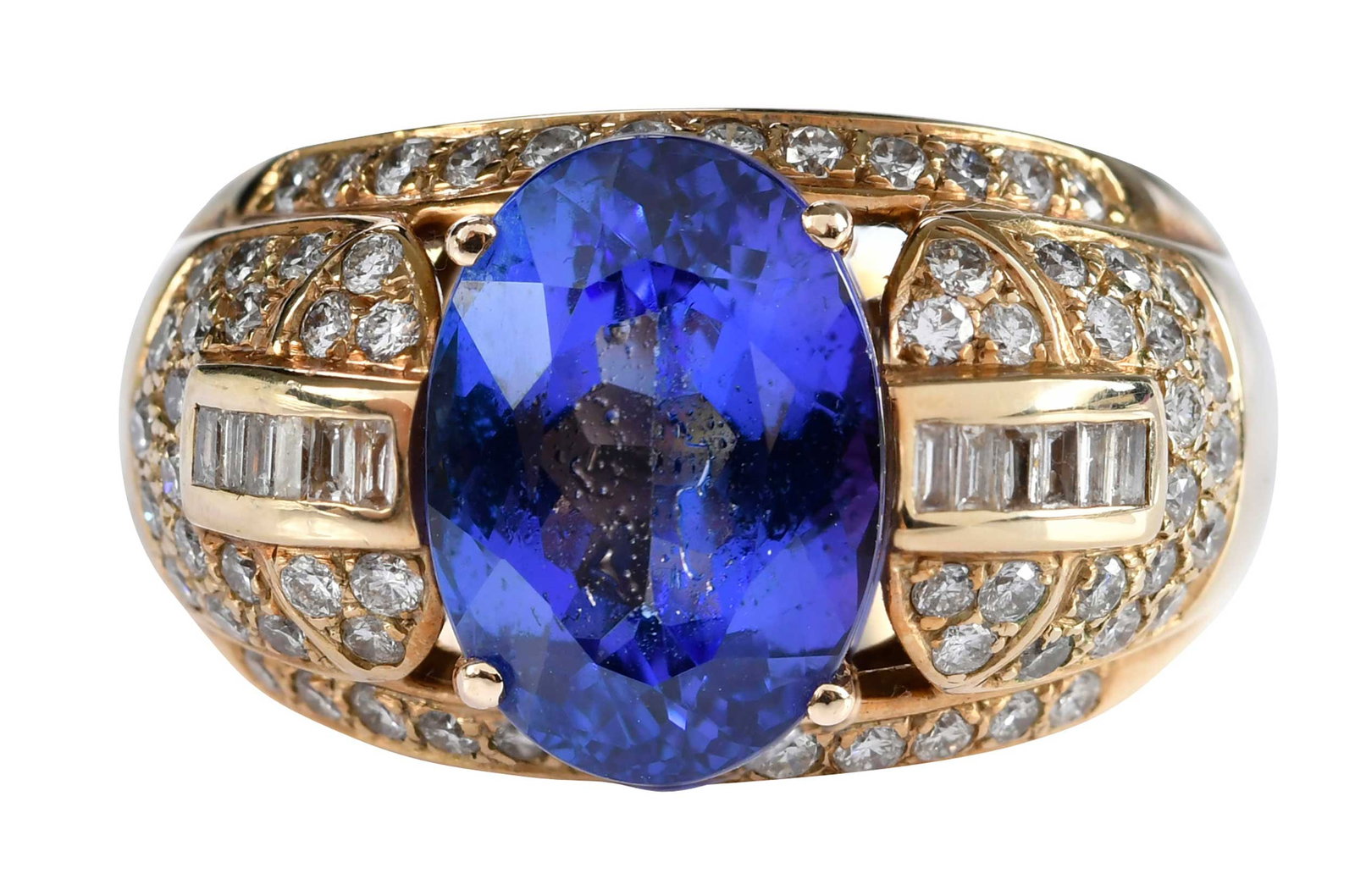 14kt. Oval Tanzanite and Diamond Cocktial Ring: oval faceted tanzanite, approx. 7.00ct., round faceted and straight baguette cut diamonds, SI, G-H, approx. 1.65ctw., SI, G-I, tests 14kt. yellow gold, 9 ring sz., 15.9 g Provenance: Private Collectio