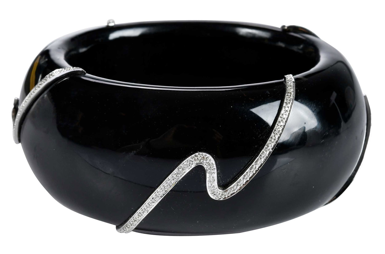 18kt. Wide Black Bangle Bracelet with Wave of Diamond Accents: round faceted diamond accents, heavy black bangle, tests 18kt. white gold, 8 in. inside measurement, 1-1/2 in. width, 373.0 g Provenance: Charlottesville, Virginia Collection Note: Brunk Auctions make