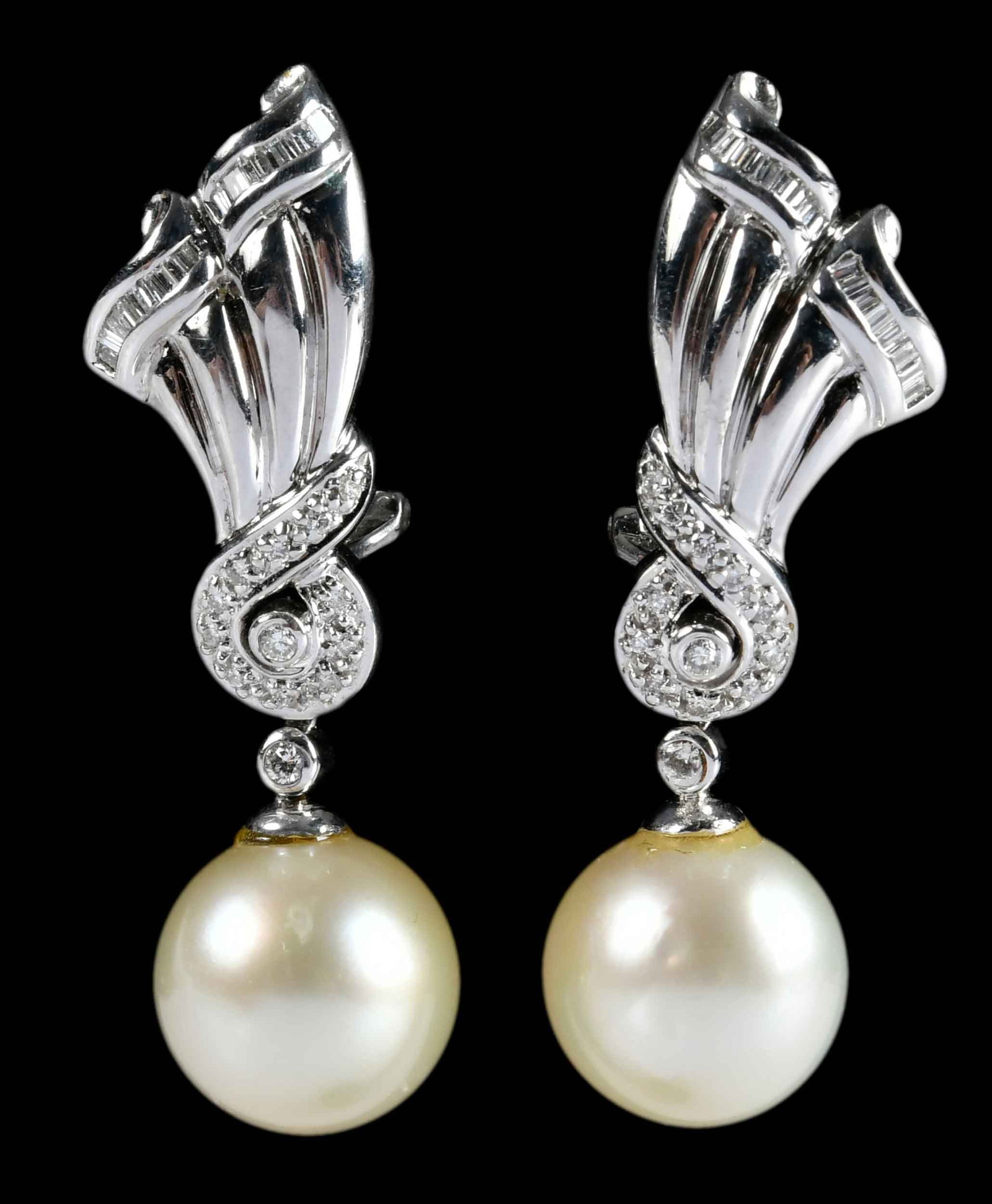 14kt. Cultured South Sea Pearl and Diamond Drop Earrings: two round cultured pearls, approx. 12.5 - 13.0mm, accented by round faceted and baguette cut diamonds, approx. 0.50ctw., marked "14K, 585", white gold, 1-5/8 in. length, 15.3 g Provenance: Private Col