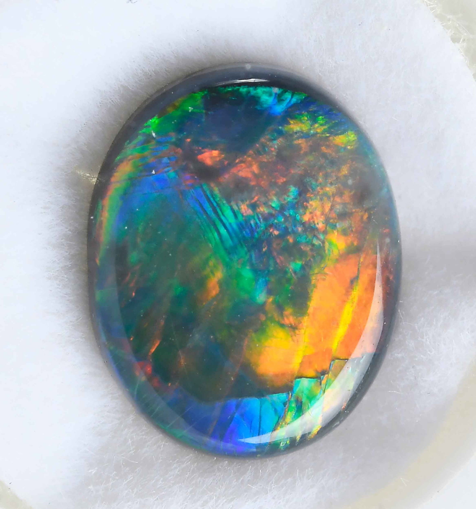 Natural Loose Lightning Ridge Black Opal 2.96ct. - GIA: oval double cabochon, 11.60 x 9.28 x 4.20mm, GIA 2233618158, translucent to opaque, display of color, no color treatment Provenance: Private Collection Note: Brunk Auctions makes no warranty or guaran