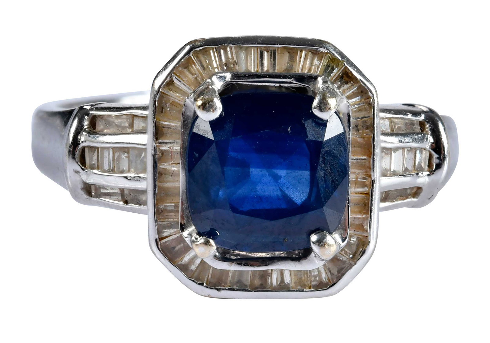 18kt. Blue Sapphire and Baguette Diamond Halo Ring: cushion cut blue sapphire, approx. 2.10ct., 52 channel set baguette cut diamonds, marked "18K, 054", white gold, maker's mark, 8-1/2 ring sz., 6.2 g Provenance: Private Collection, Virginia Beach Note