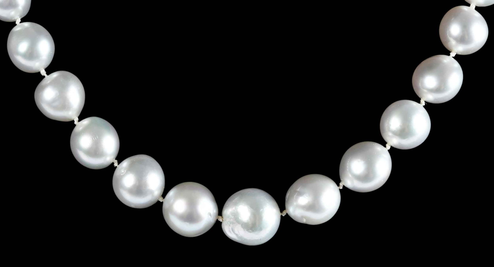 14kt. Single Strand White South Sea Semi Baroque Pearl Necklace: 36 South Sea white pearls, approx. 12.0 -13.0mm, marked "14K", yellow gold, 21 in. length, 103.9 g Provenance: Private Collection, Virginia Beach Note: Brunk Auctions makes no warranty or guarantee re